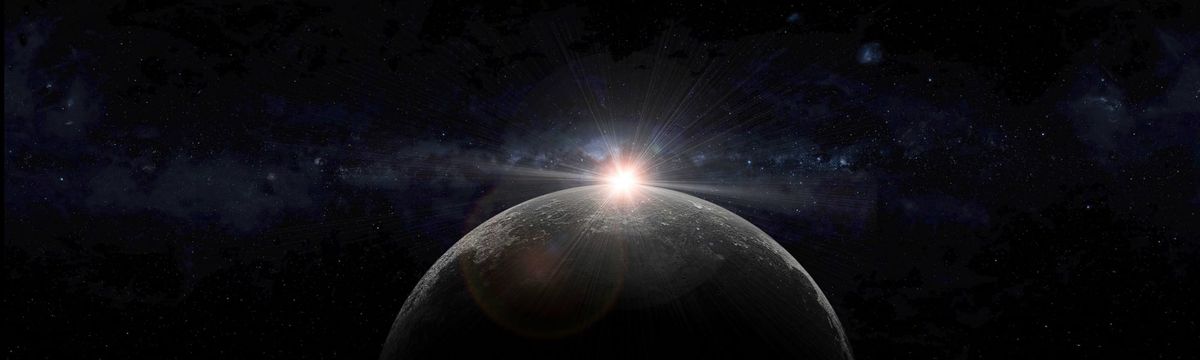 The sun setting behind the moon