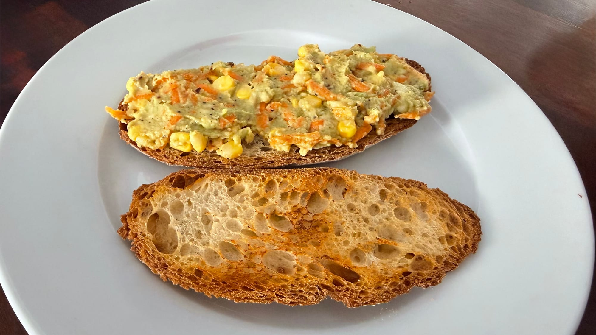 Vegetable loaded avocado toast on sourdough with avocado mash carrot corn and capsicum. Gut health breakfast recipe by Shradha Fuel It Right
