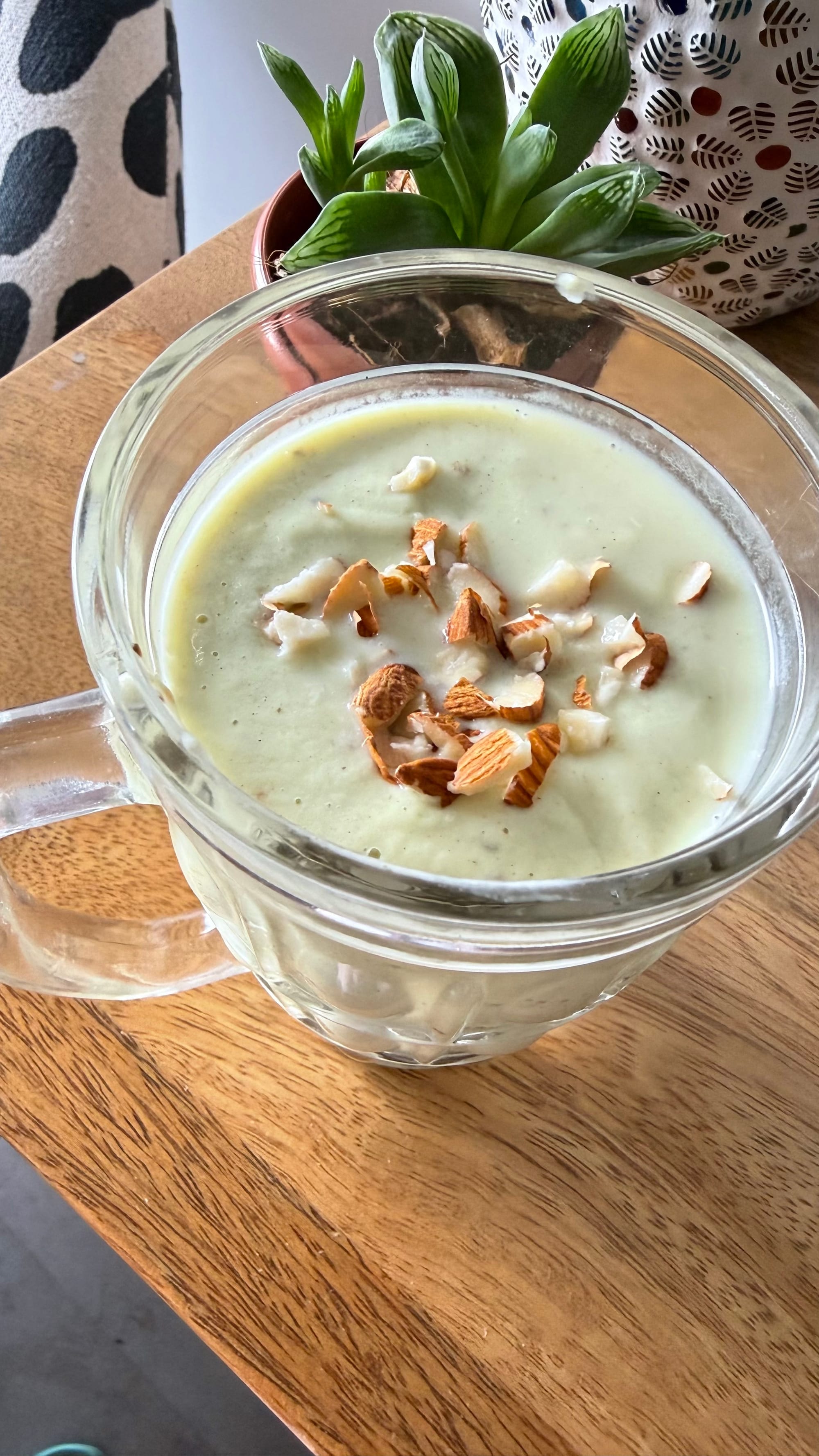 Avocado date smoothie overhead view showing crushed almond topping. Gut health blood pressure recipe by Shradha Fuel It Right