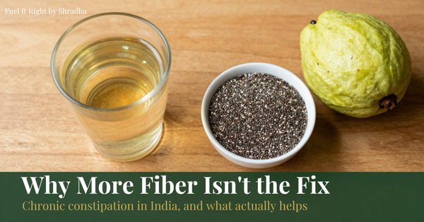 Photorealistic overhead photo of soaked chia seeds, isabgol in a glass of water, and whole fruit, with headline "Chronic Constipation: Why More Fibre Isn't the Fix" for the Fuel It Right blog