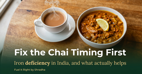 Overhead photo of a cup of chai beside a bowl of rajma curry with lemon, representing the chai-timing and iron-rich food theme of the Fuel It Right blog on iron deficiency in India