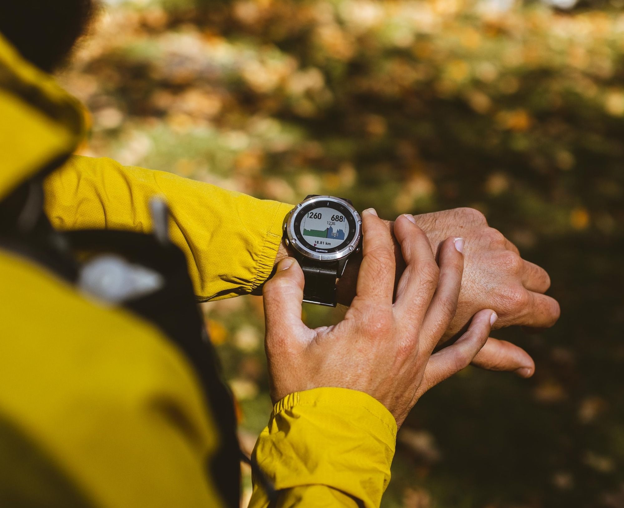 a man in a yellow jacket holding a compass