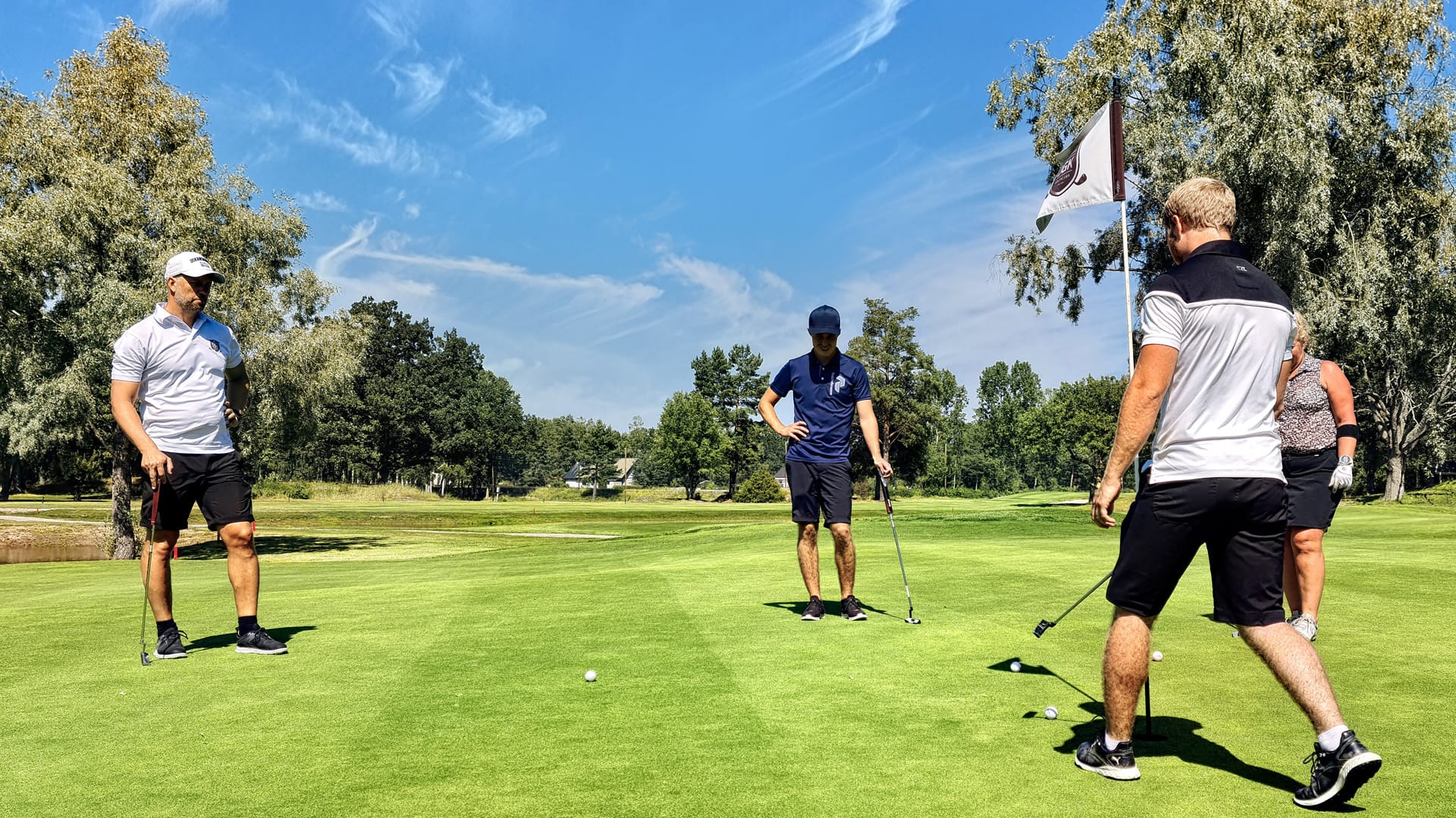 A group of 4 friends playing golf
