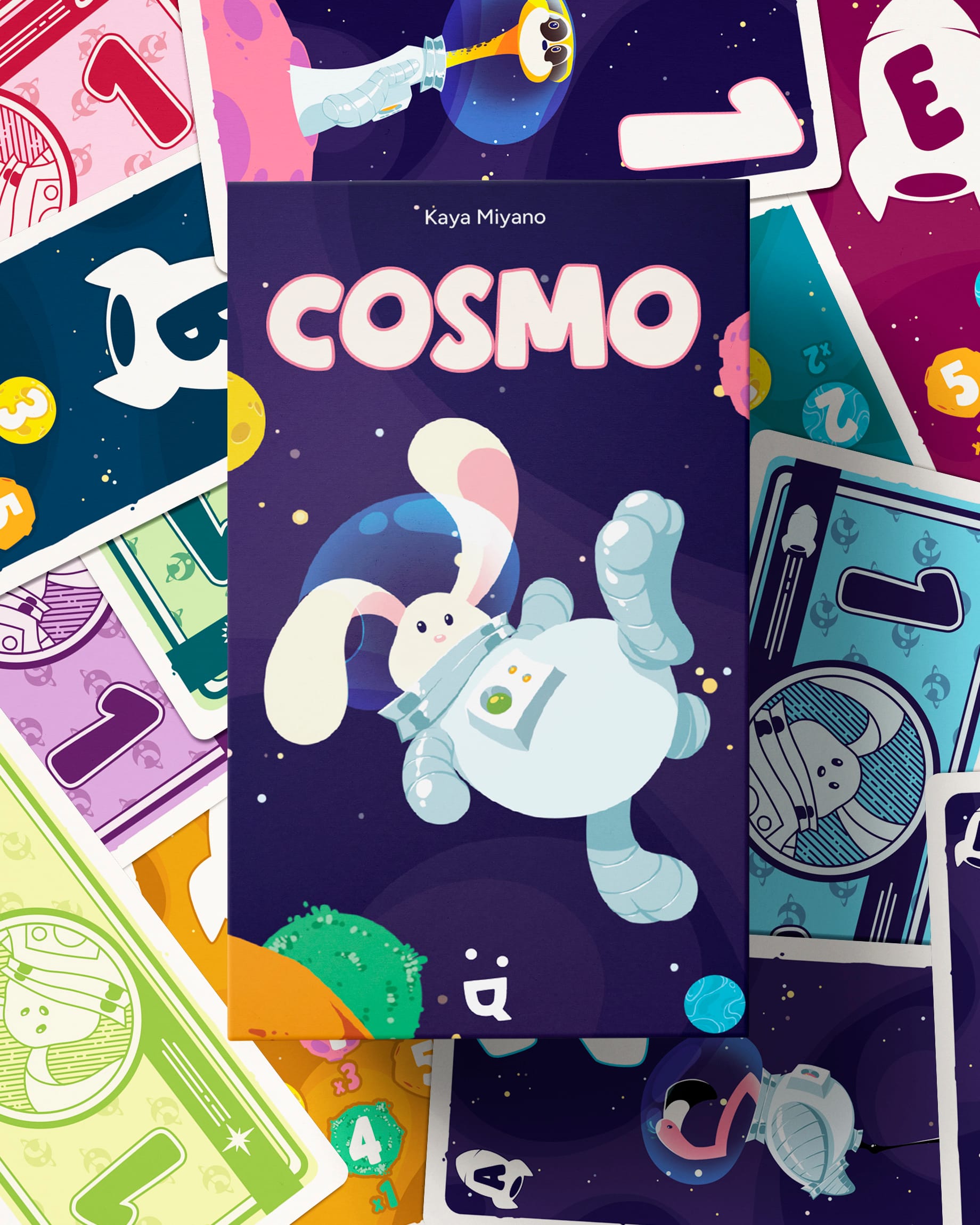 The front cover of Cosmo in front of various cards from the game