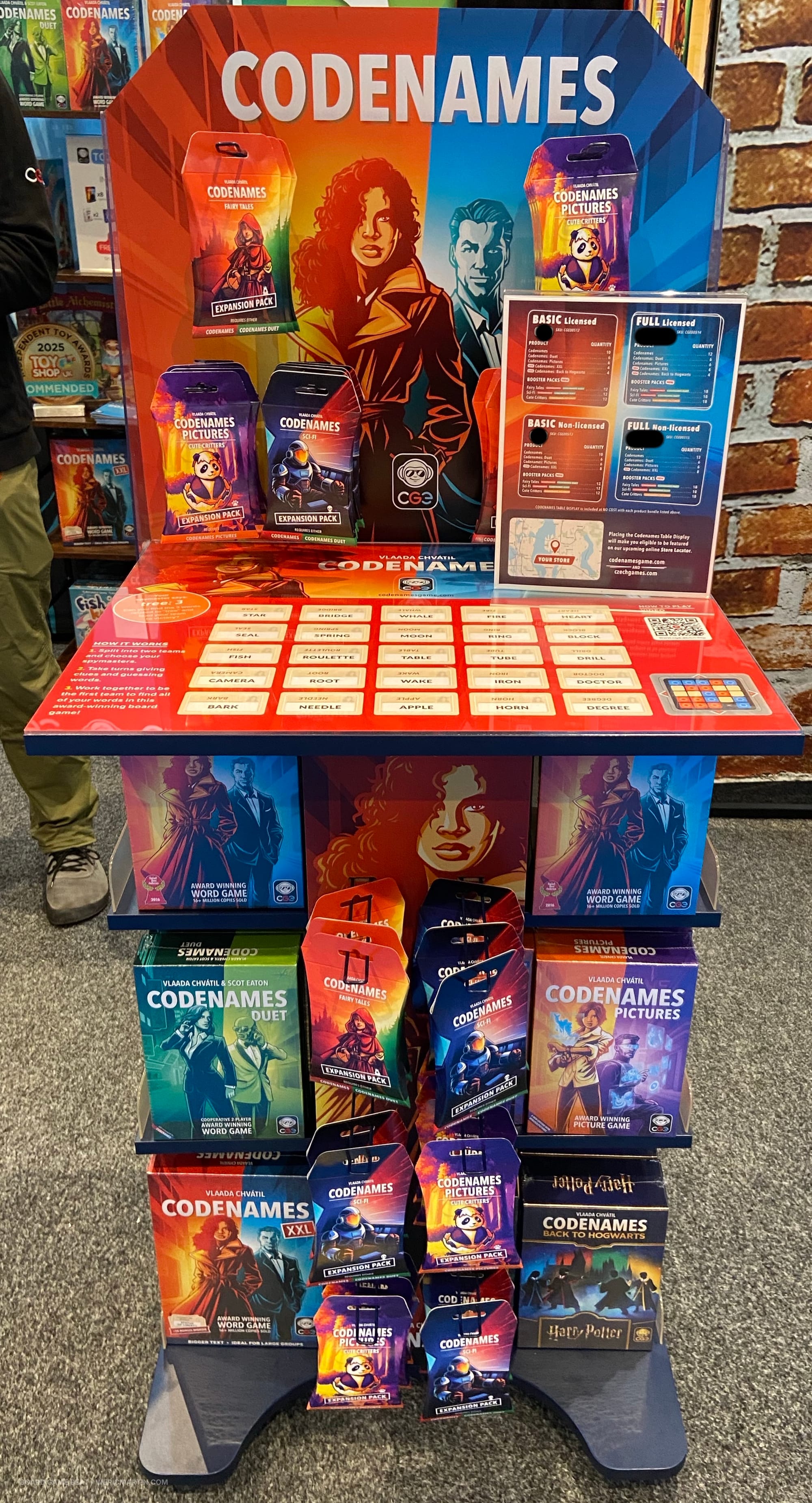 A stand-up retail display for Codenames that features both base games and expansion packs