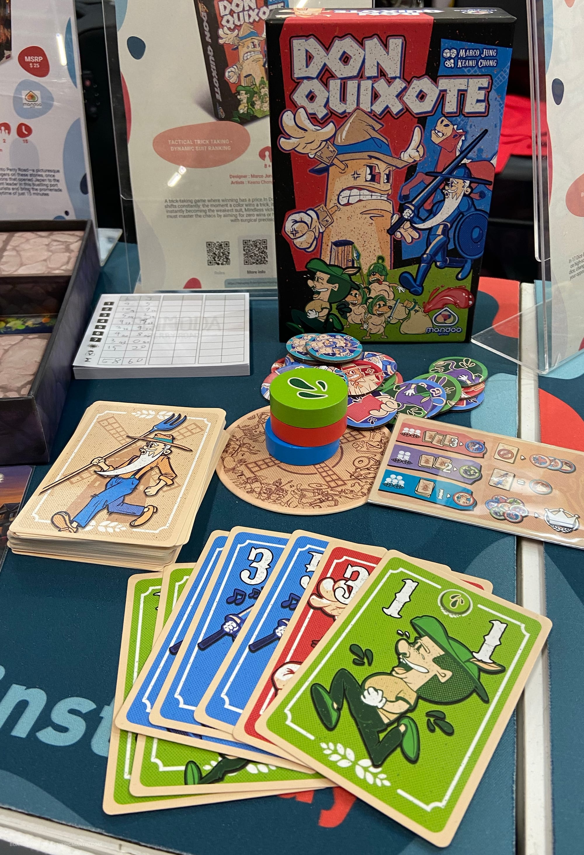 Front cover of Don Quixote, along with sample cards, point tokens, and the suit-ranking chips