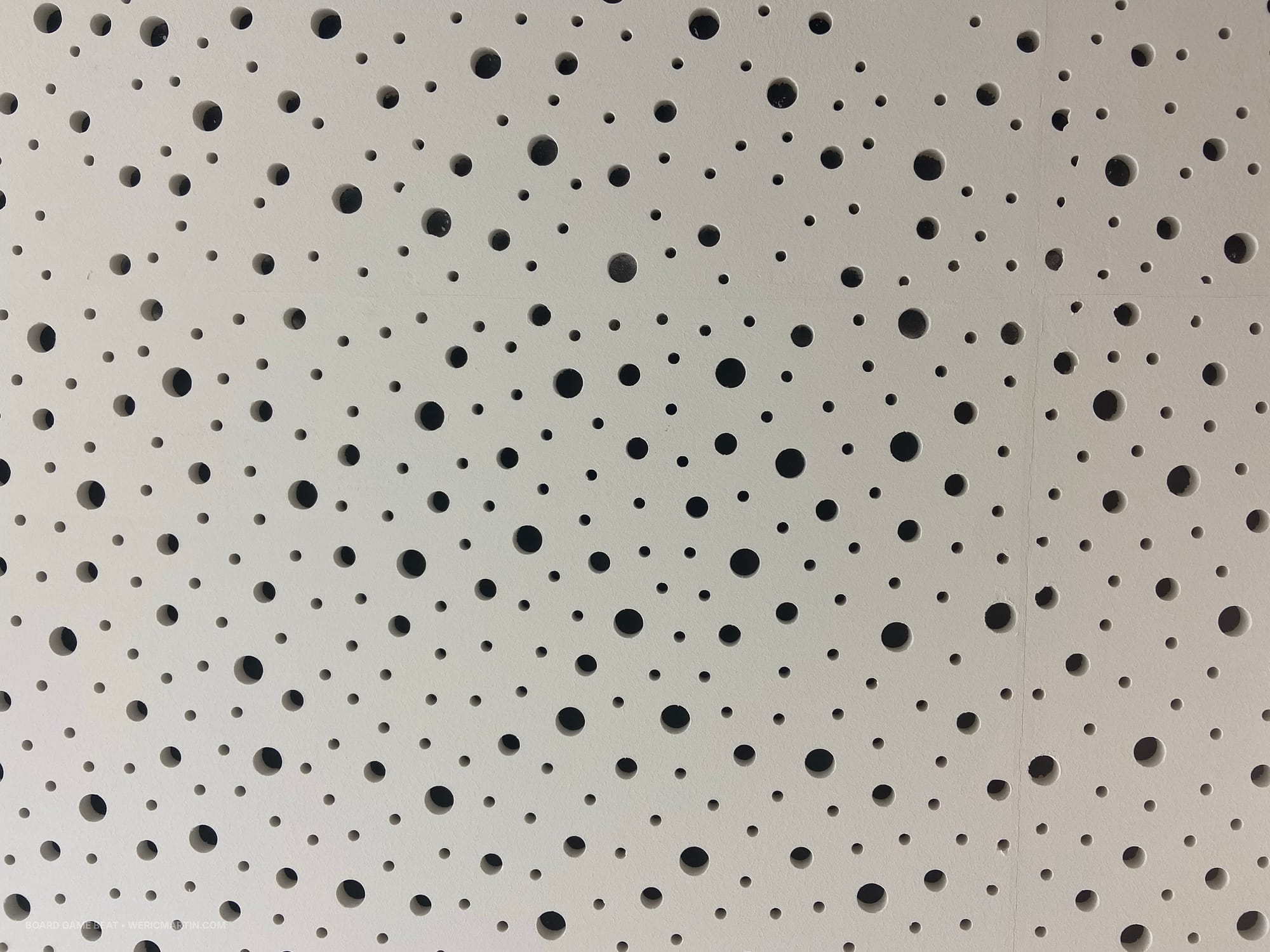 A ceiling tile filled with holes