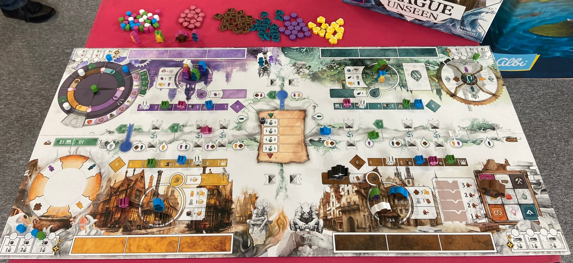 A game board showing four regions of play, along with many wooden bits