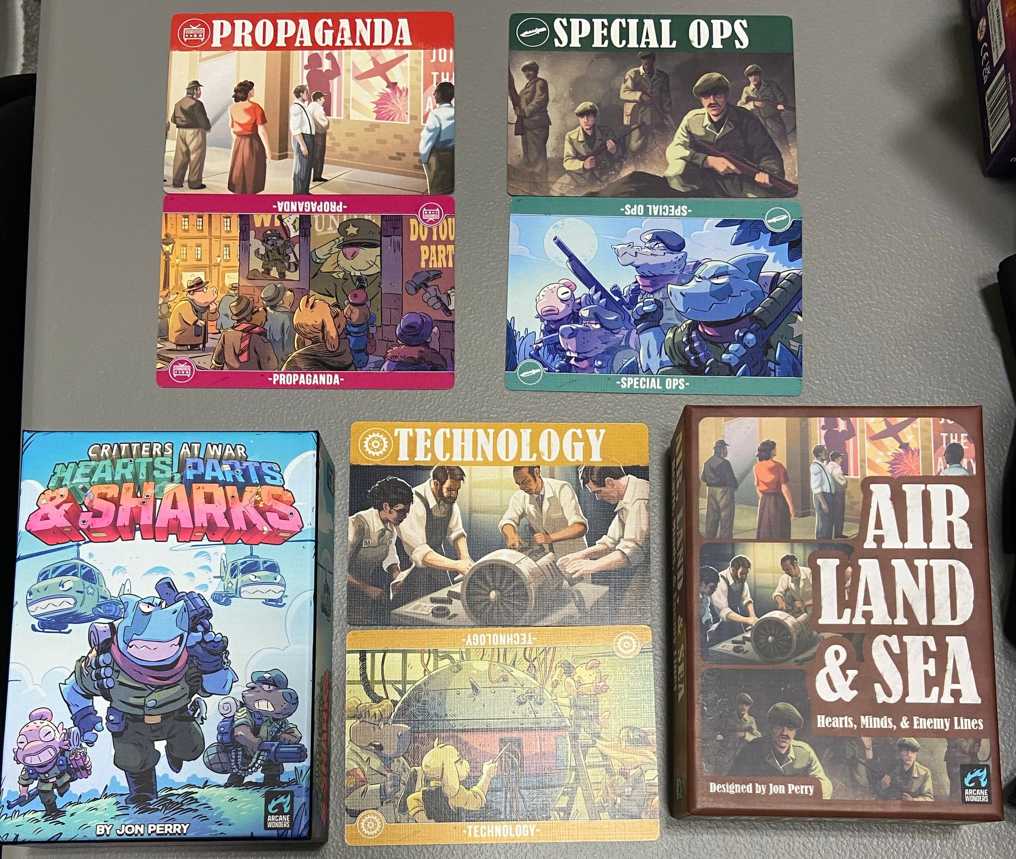 Two game boxes are depicted: Critters at War: Hearts, Parts & Sharks and Air, Land & Sea: Hearts, Minds & Enemy Lines