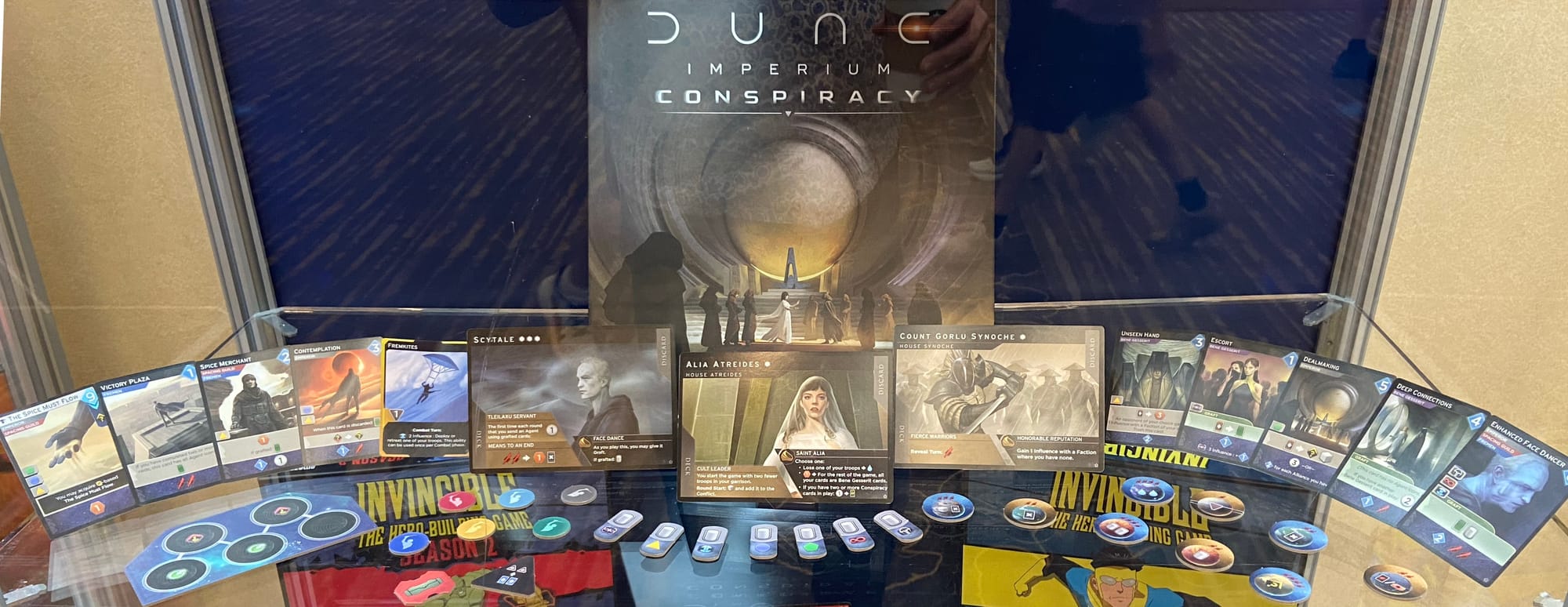 The front cover of Dune: Imperium – Conspiracy is on display, along with character cards, tokens, and other cards.
