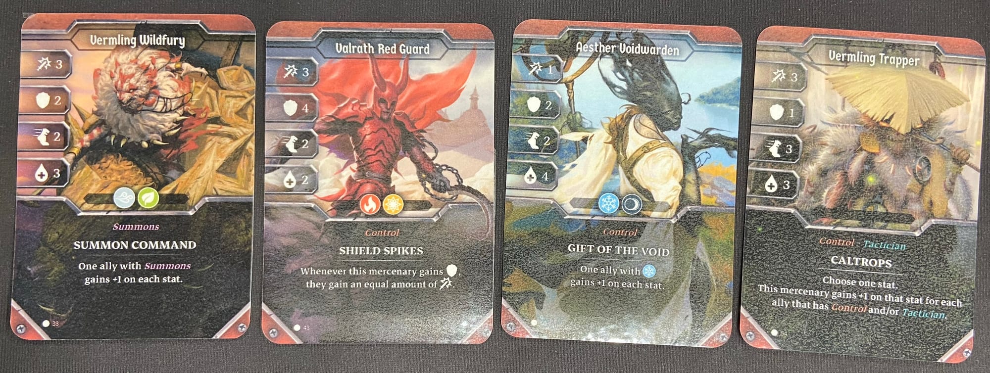 Each card features attack, shield, move, and heal values, along with some combination of tags, element symbols, special abilities, art, and a name.