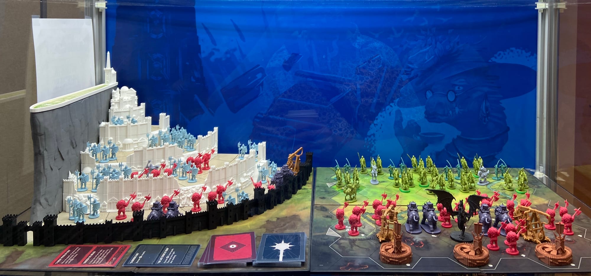 Dozens of plastic figures stand in a plastic castle and on game boards.