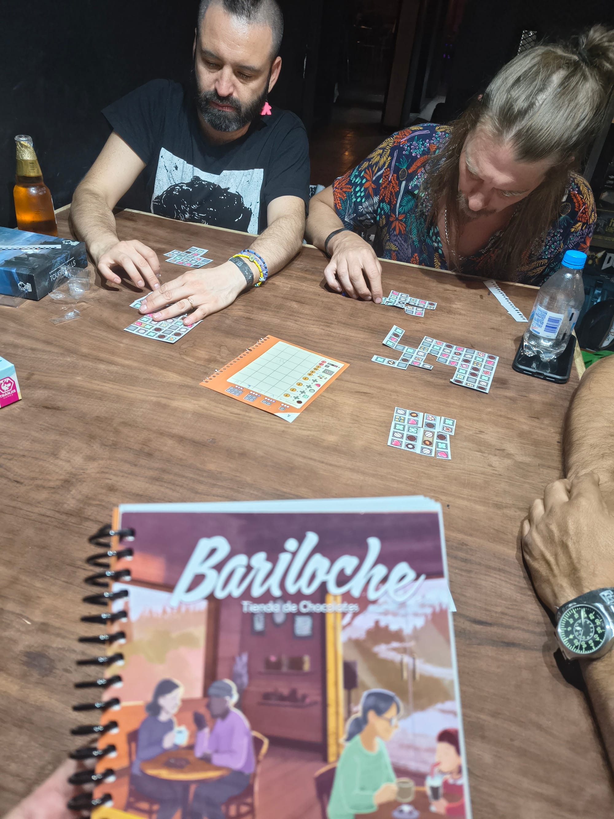 Players are building chocolate boxes with rectangles they have torn from paper bonbon sheets.