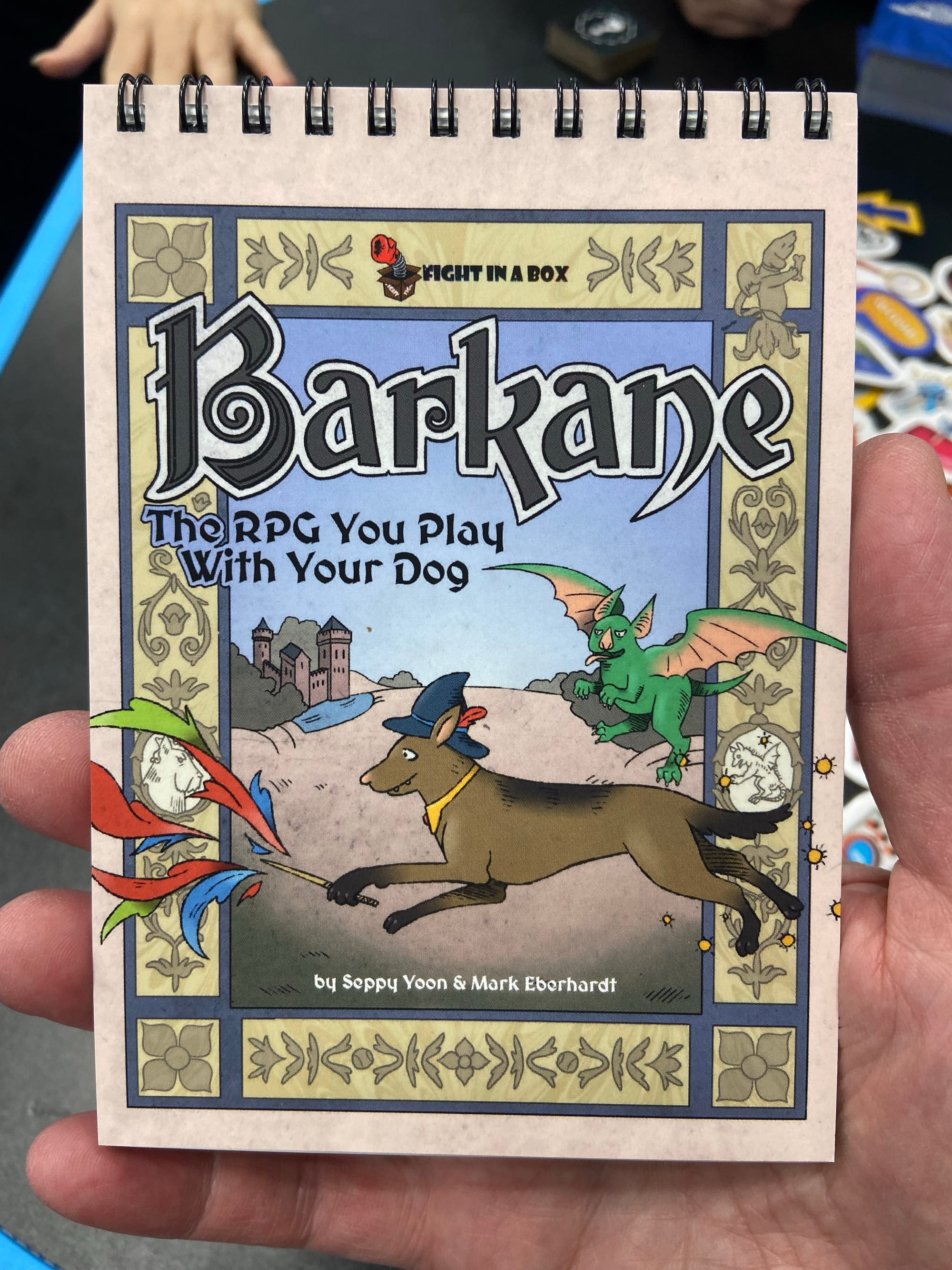 A spiralbound book is titled "Barkane: The RPG You Play with Your Dog"