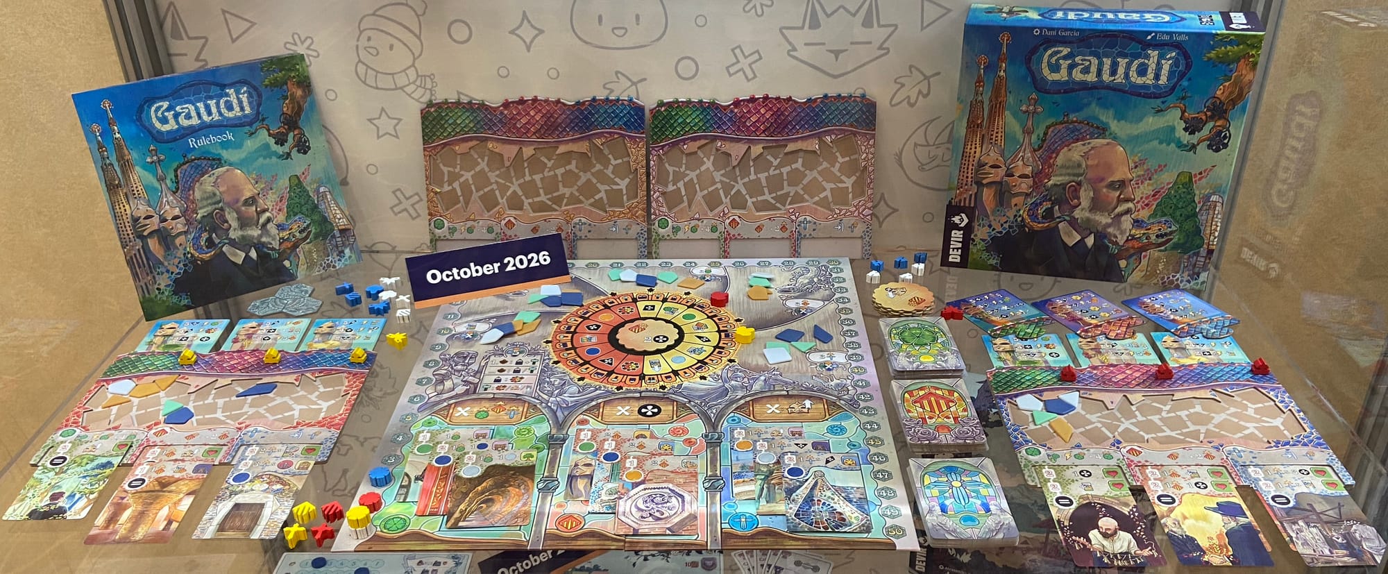 The box for Gaudí depicts the architect in profile against a colorful background; this display case also features the central game board around which players move and individual boards where player place cards and tiles.