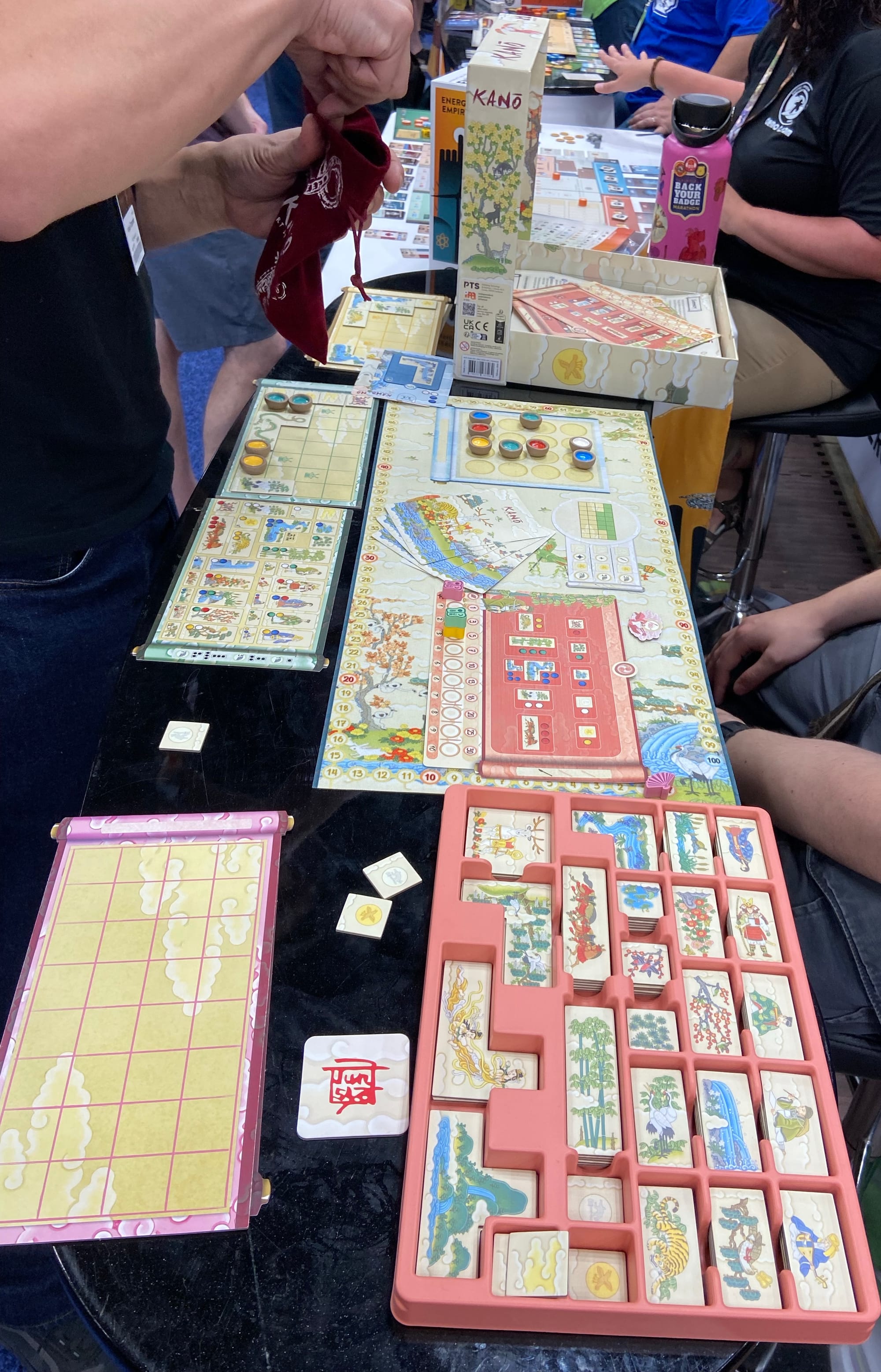 A central game board features colored paint pots in a 4x4 grid, and a player's game board shows paint pots on their board along with pictures "painted" previously.