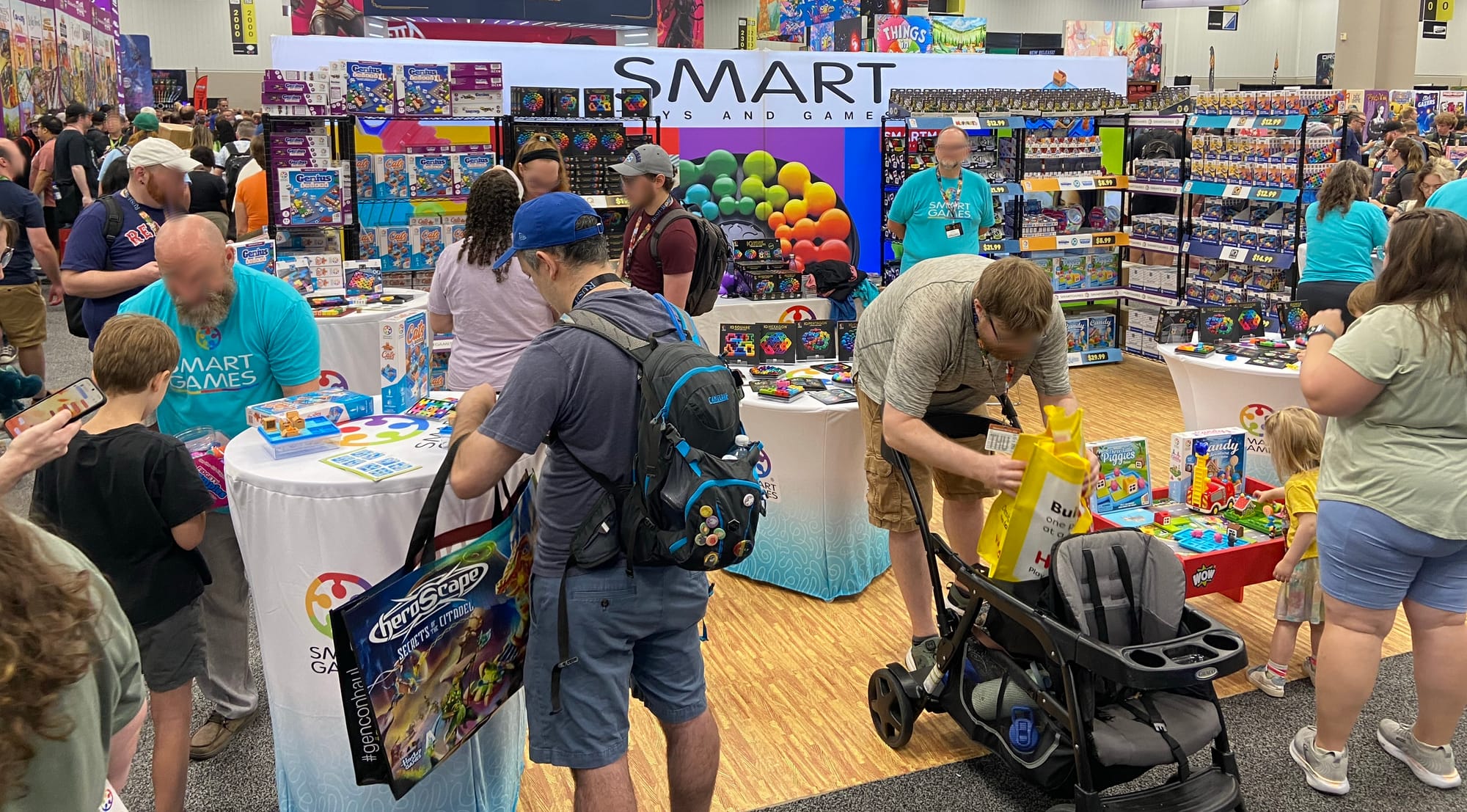 The Gen Con 2026 booth for Smart Toys and Games, which is filled with workers and attendees.