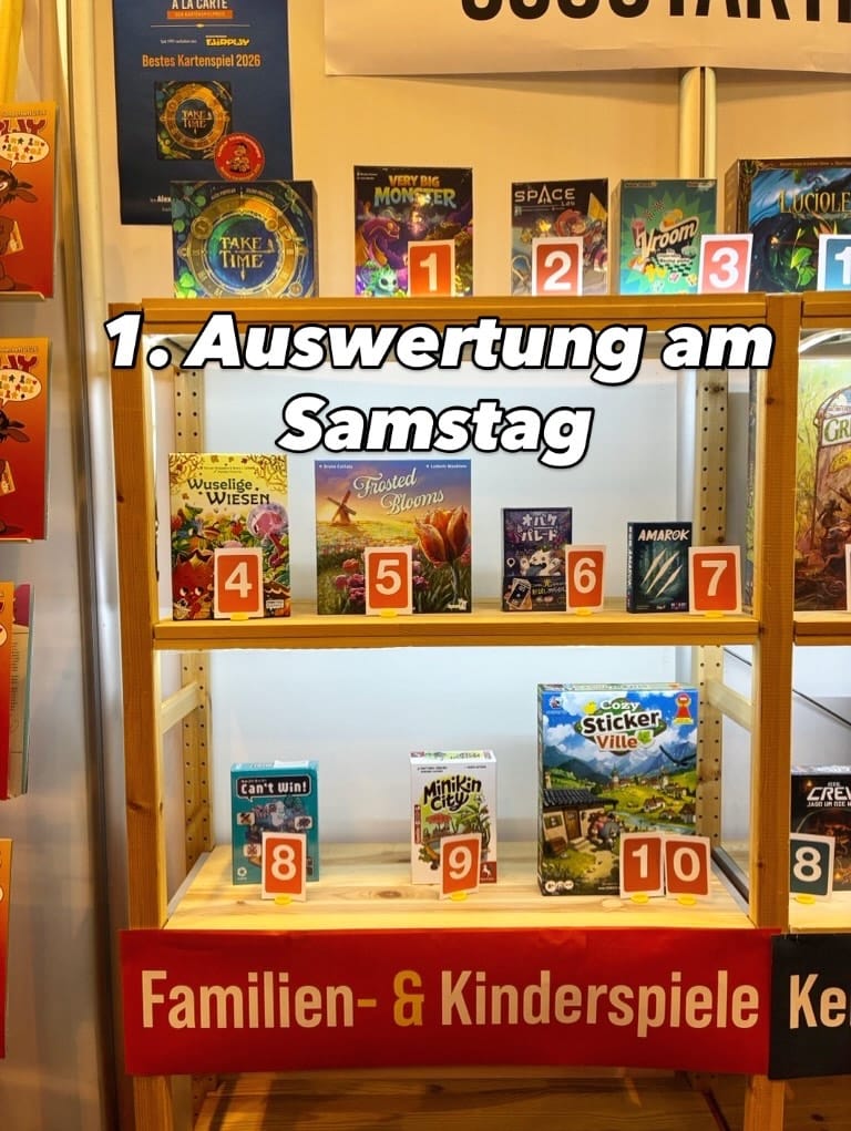 Ten games are on wooden shelves numbered #1-10. In order: Very Big Monster, Space, Vroom, Wuselige Wiesen, Frosted Blooms, Night Parade, Amarok, Can't Win!, Minikin City, and Cozy Stickerville.