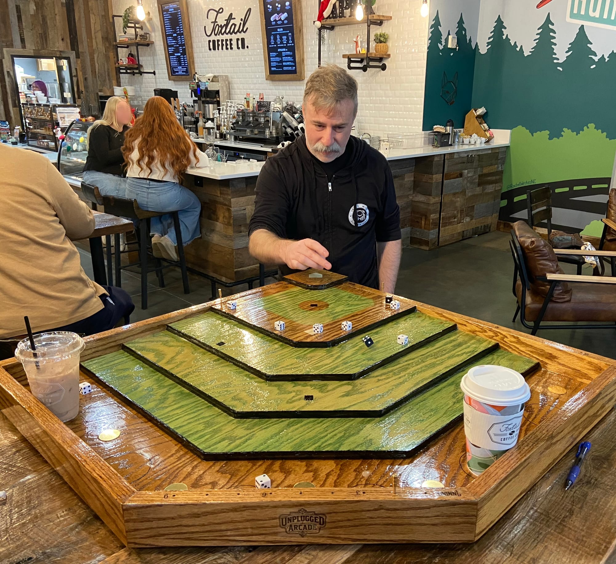 The image is the same as at the top of the page, but now you can see the person playing this game, who has just launched a die from home plate into the outfield.