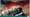 Under the banner "A game by Carla & Jeff Horger", we see a black-and-silver train emitting smoke, while moving into a cityscape that features clouds reddened by the sunset in the background.