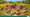 This cropped cover of Ährensache shows a farm that looks crafted from cut-out paper and cardboard components. 