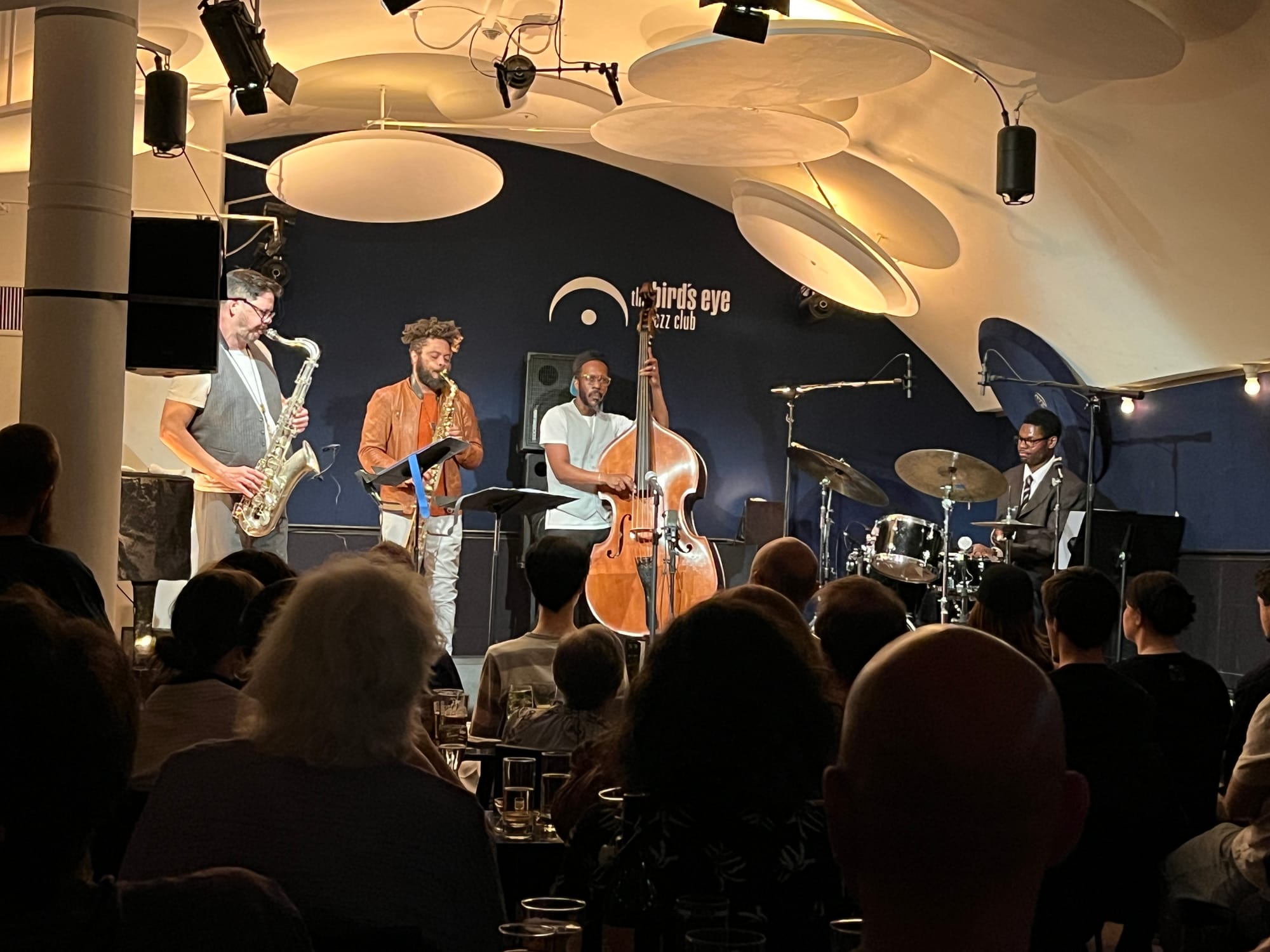 Two saxophonists, a bassist, and a drummer