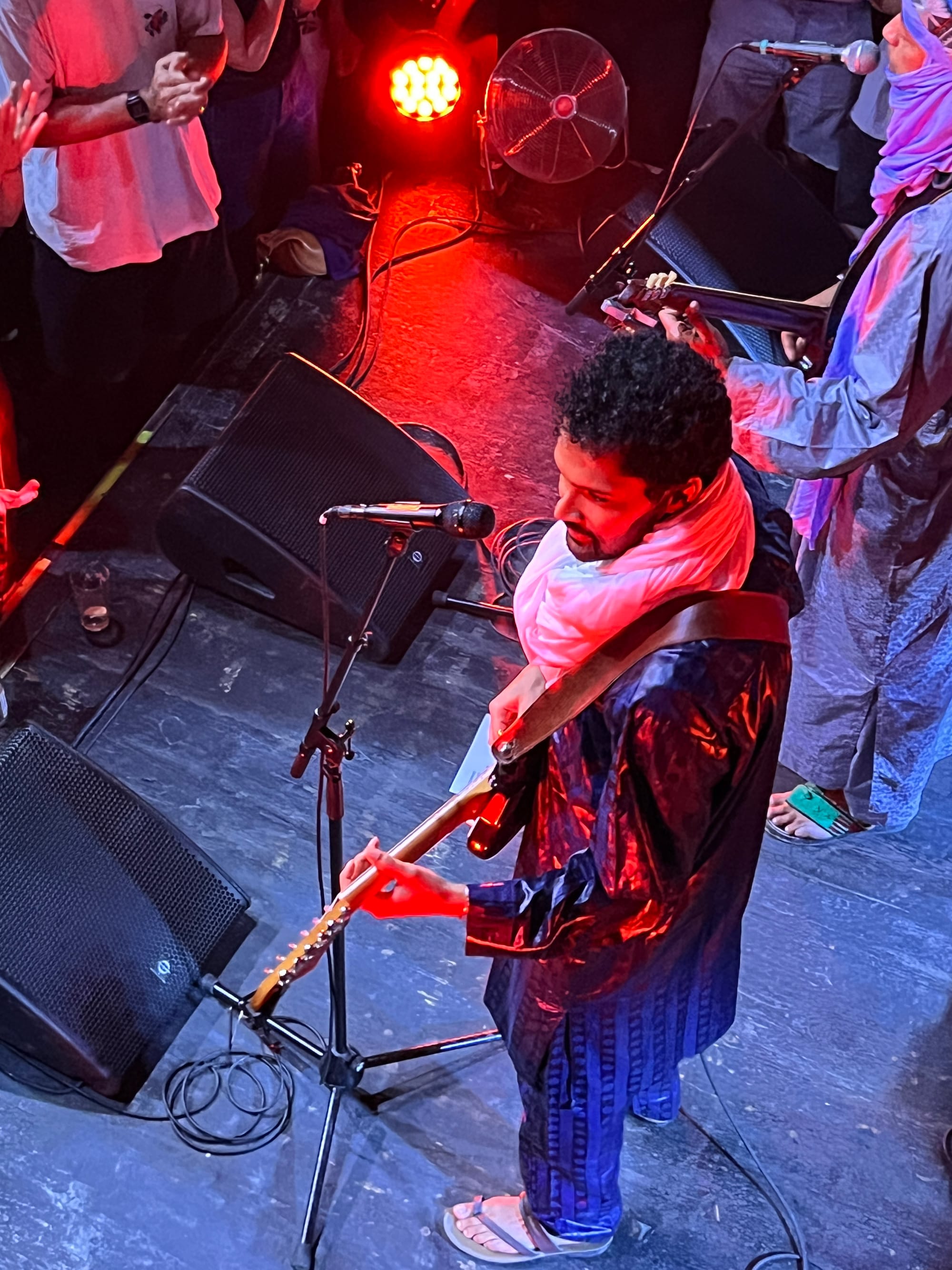 Looking down at an electric guitarist in flip flops