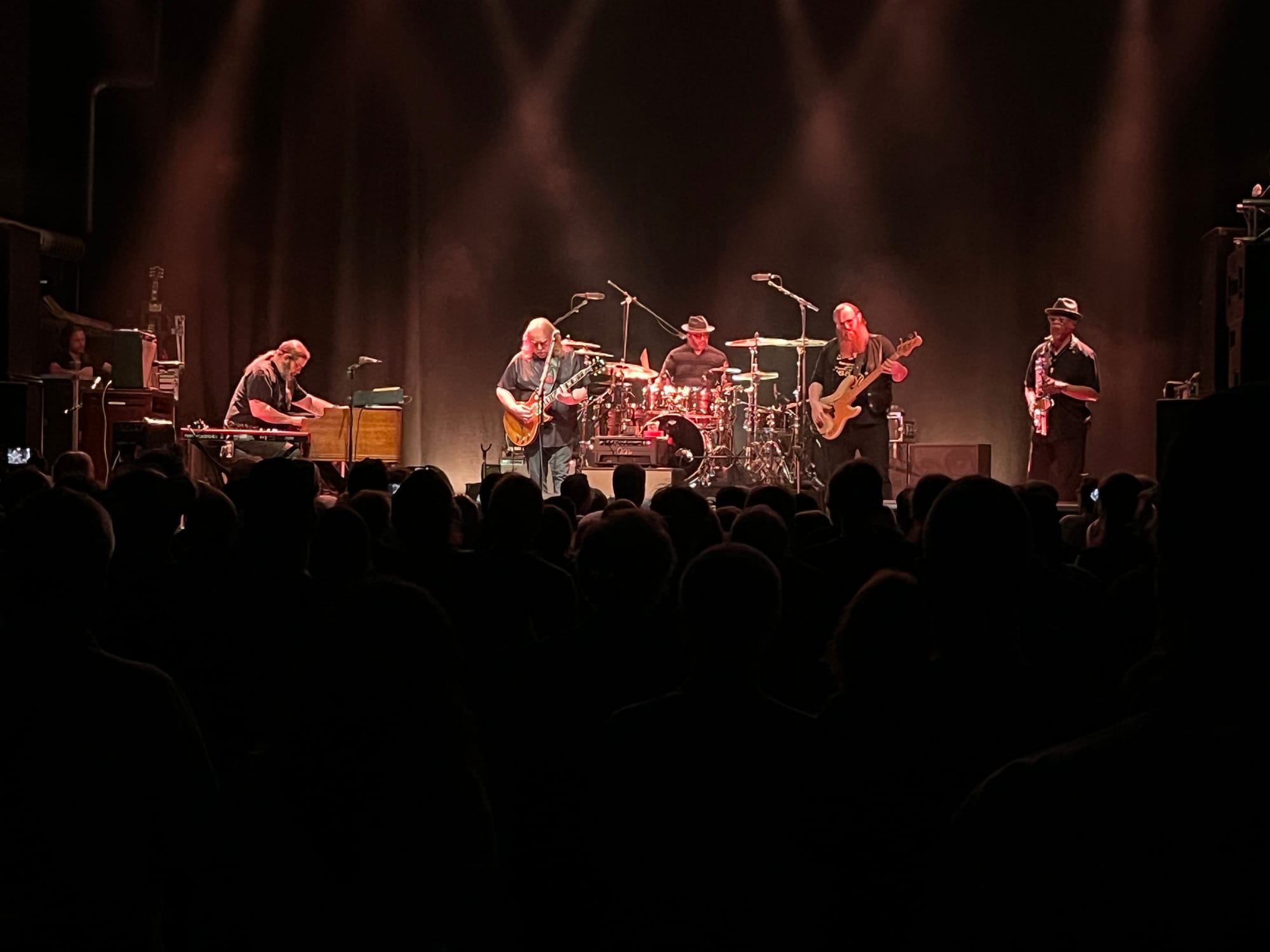 A five-piece band on stage from a distance