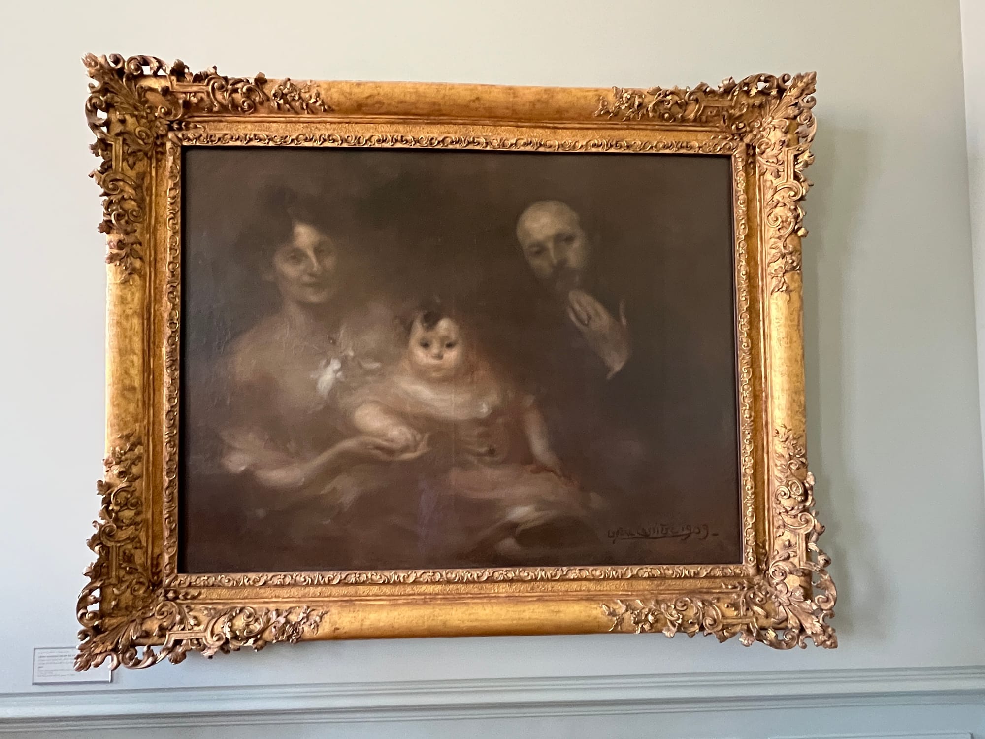 A painting in the same style as the above painting, this time with a mother, father, and baby.