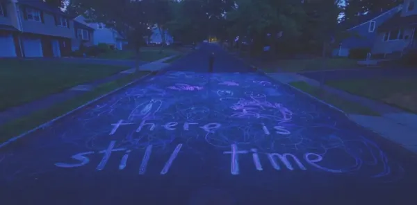 the secene from i saw the TV glow where chalk on the street says "thre is still time"