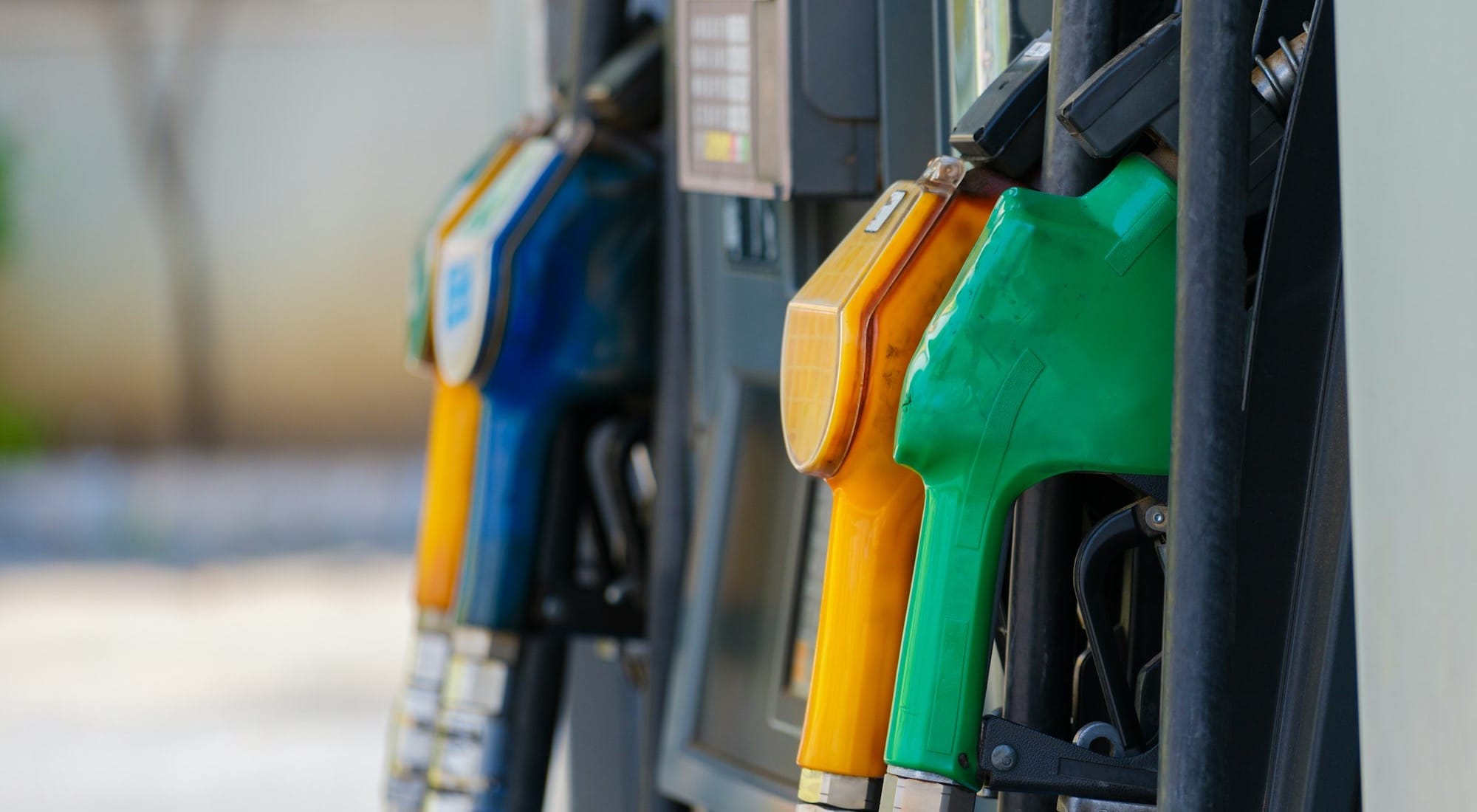 a row of gas pumps filled with gas