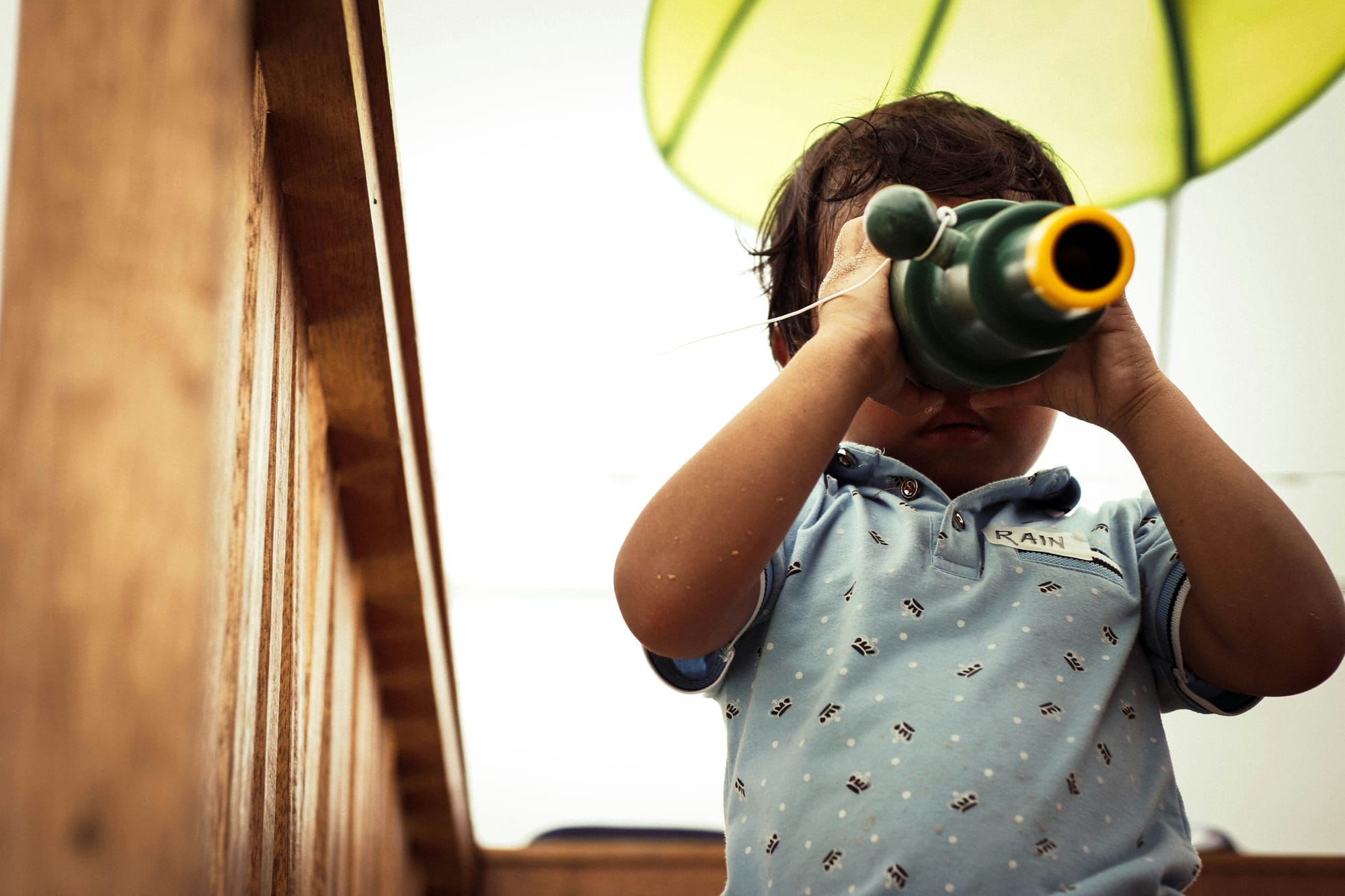 A toddler checks out the view through a monoscope.