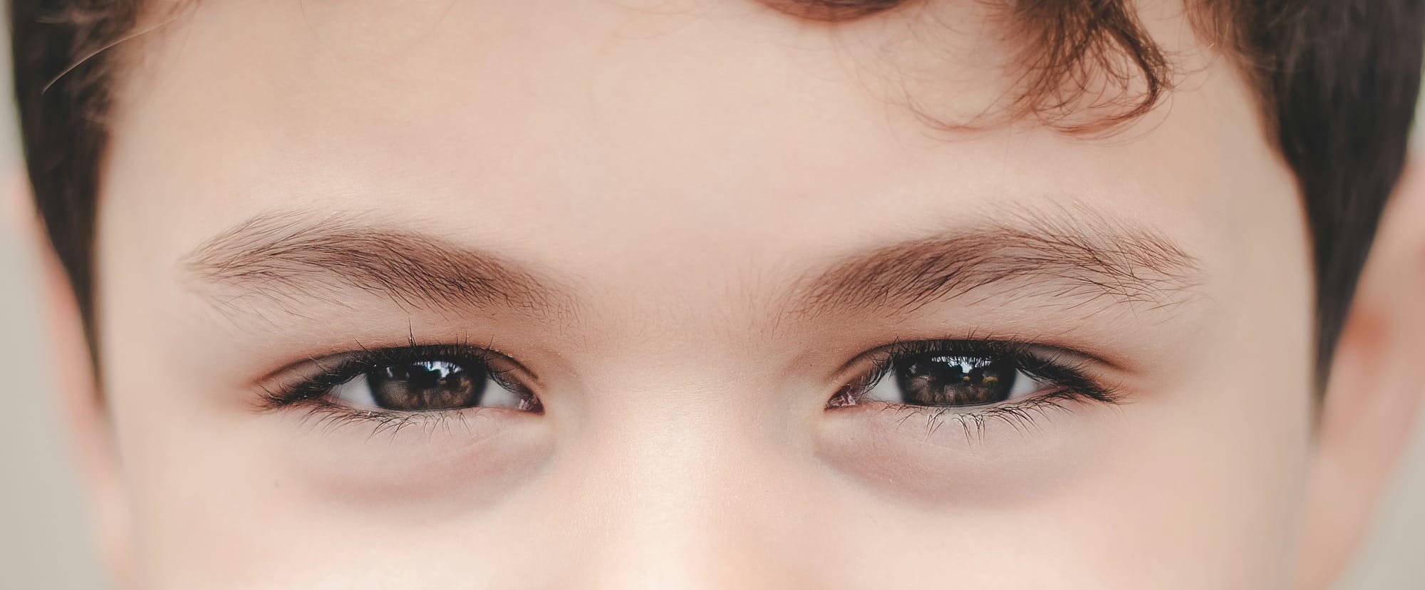 Close-up of a boy's brown eyes.