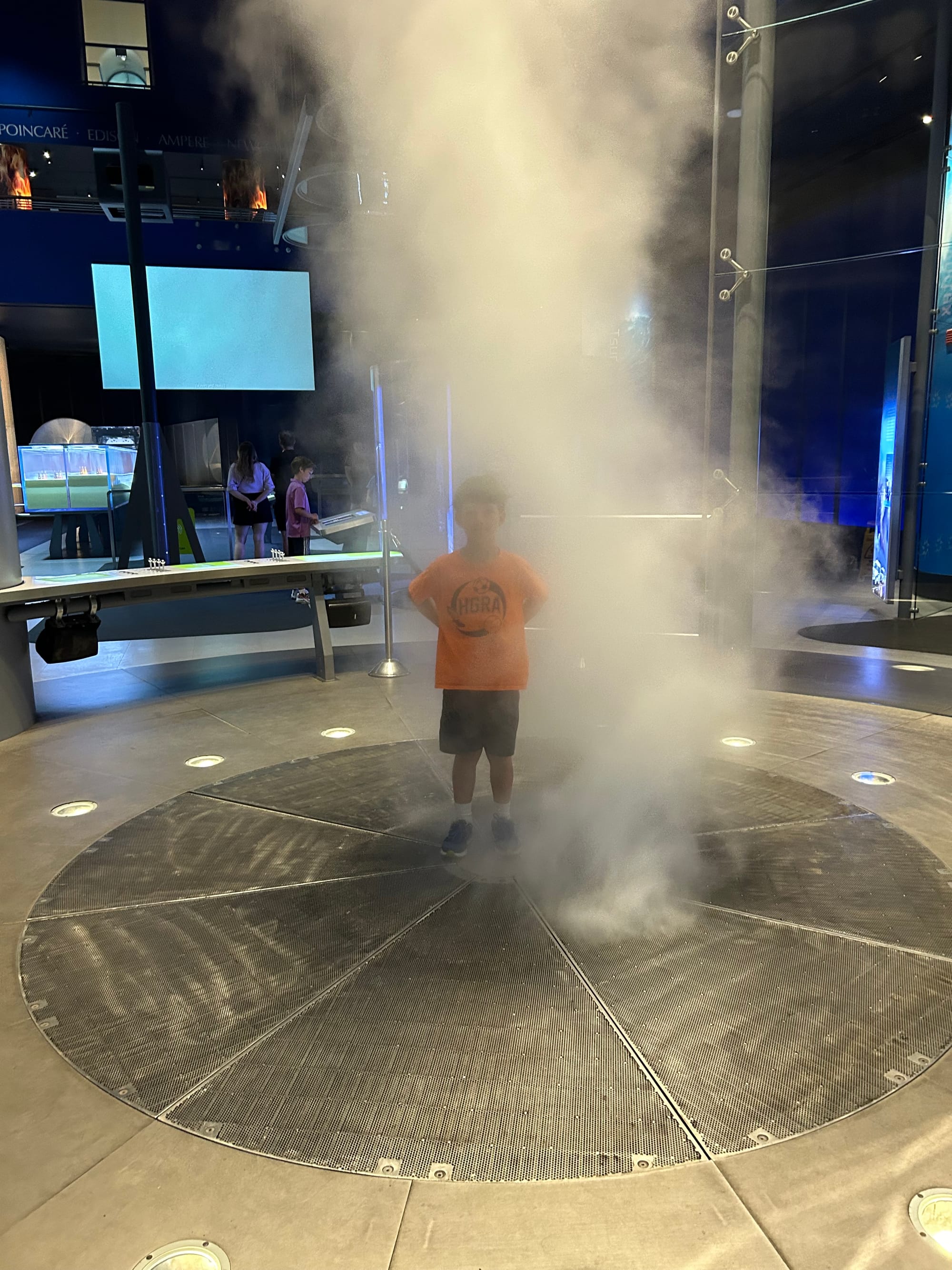 Child in center of towering whirlwind of steam at the Griffin Museum, Chicago.