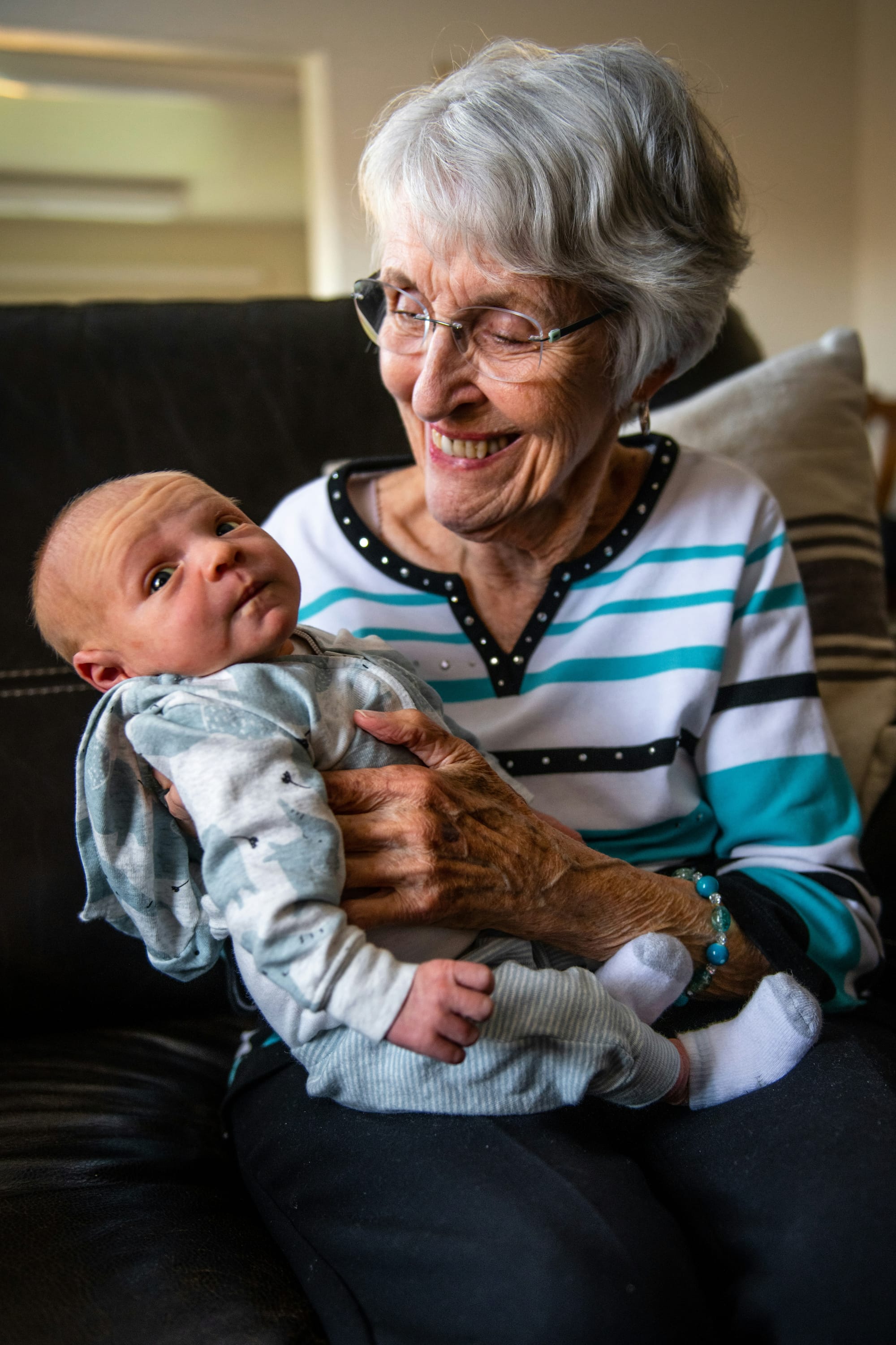 An older woman holding a baby.