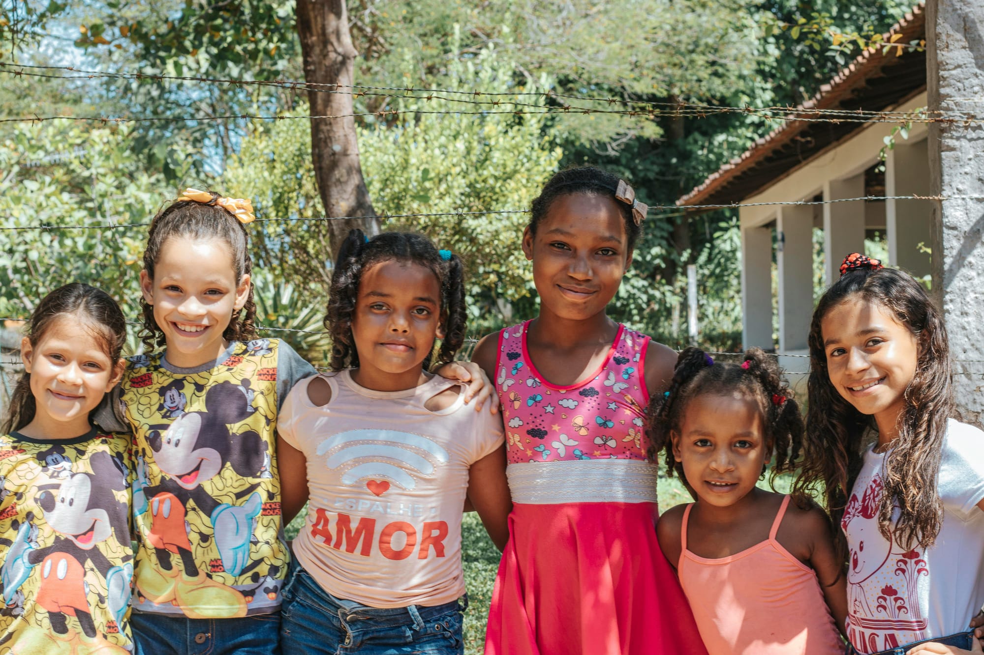 A group of school-age girls lines up, smiling. Worth fighting for, like all kids. 