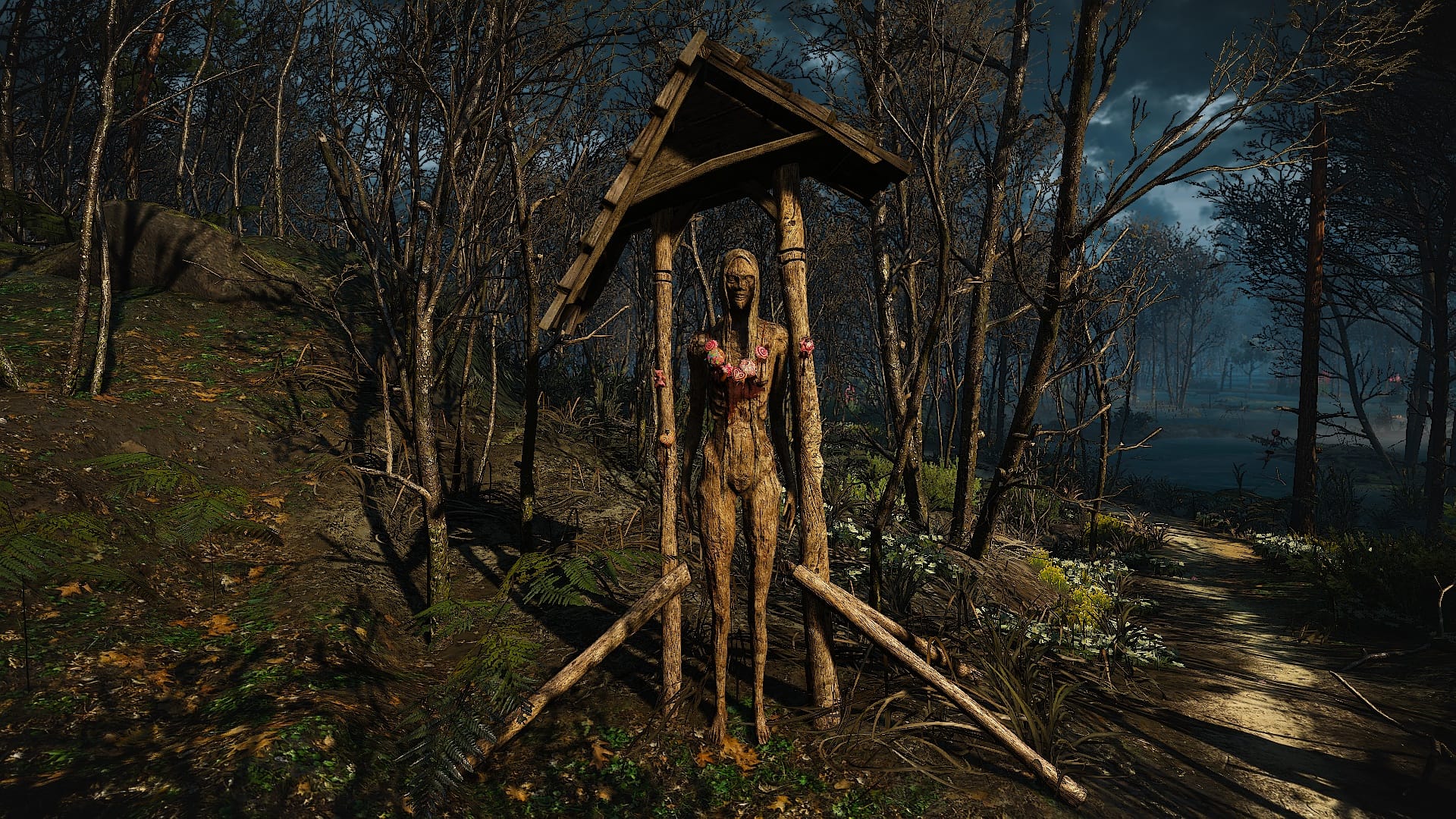 A carved figure of a witch standing in a bog