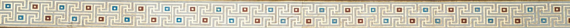 Close-up of an ornate ionic column capital with gold details.
