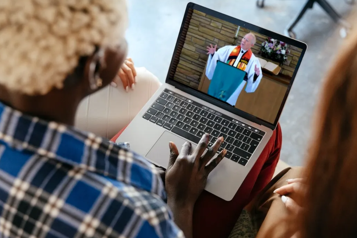black woman with friends watching preacher online