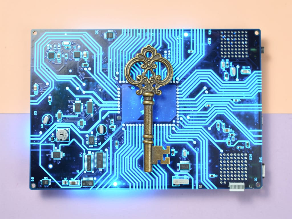 A brass key resting on a glowing blue computer circuit board