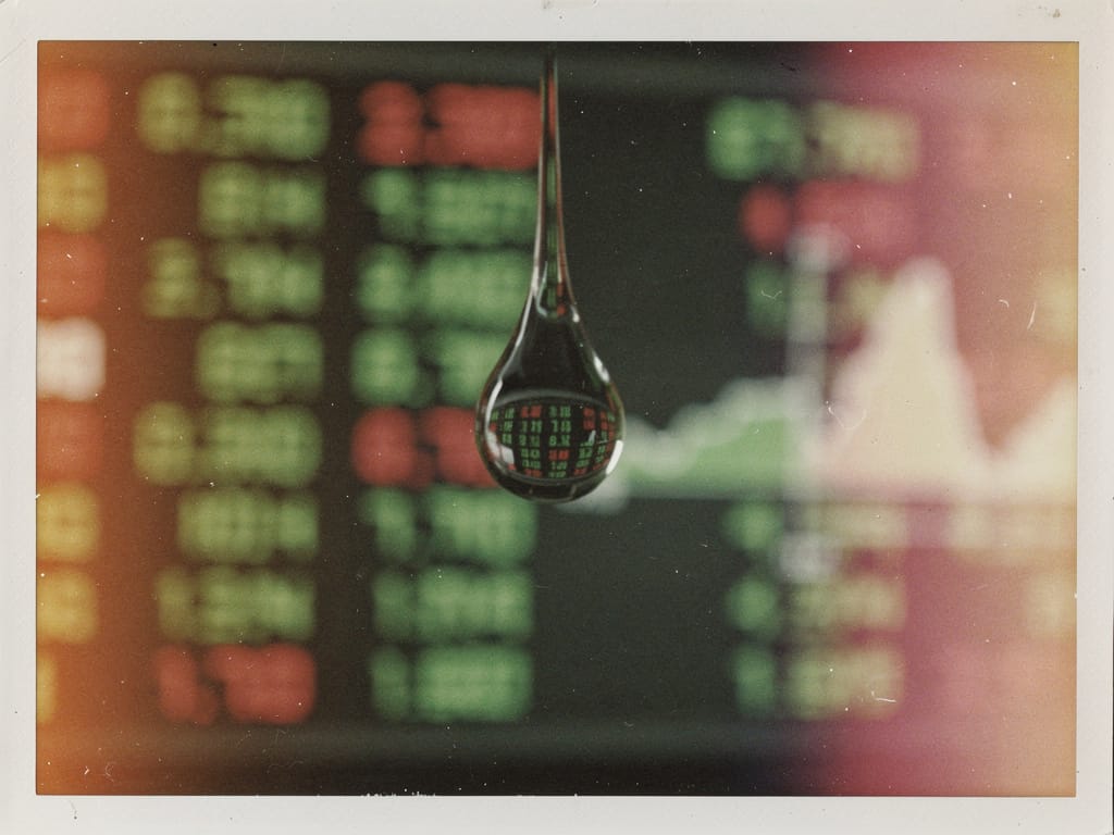 Water droplet on a stock market ticker screen