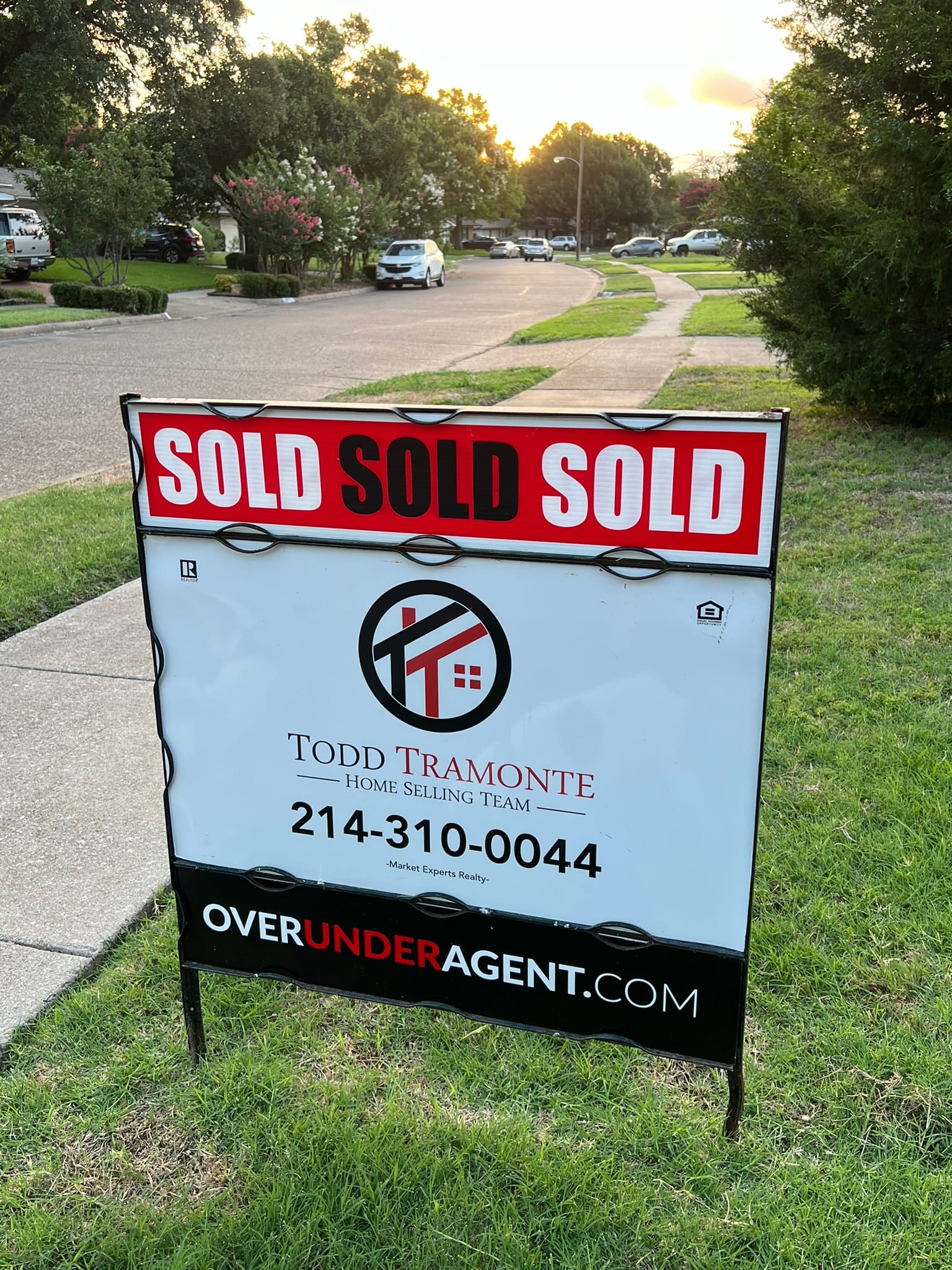 Real estate sold sign in front yard after successful house sale