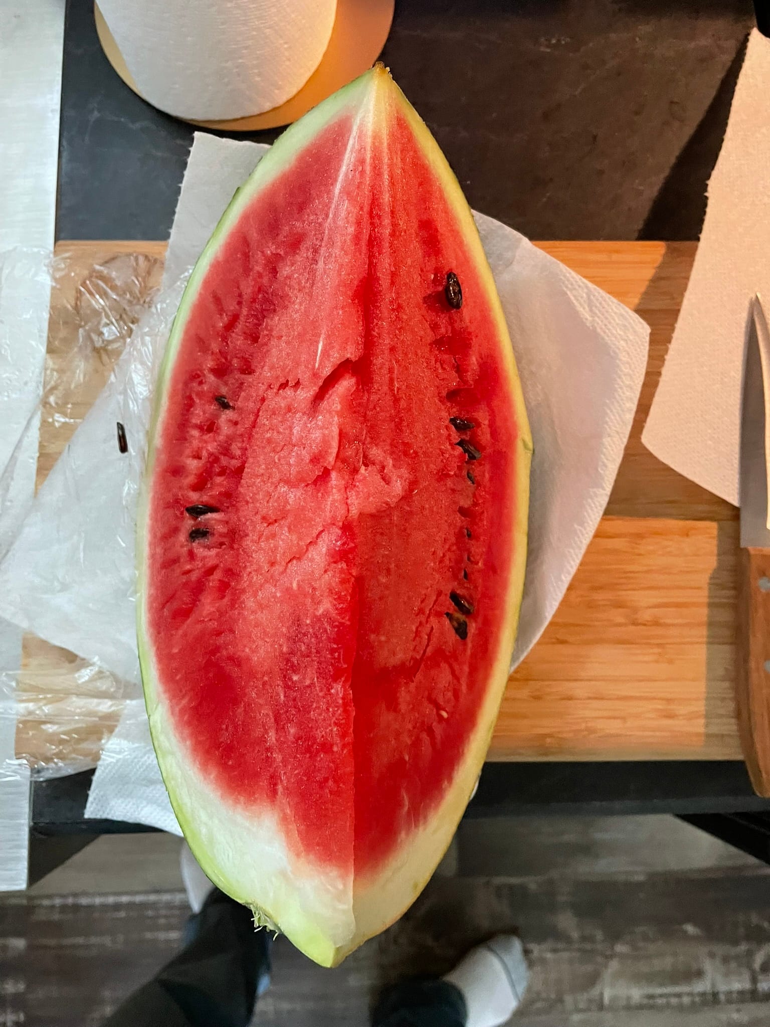 A photo of a fresh watermelon from the community garden, representing the unexpected perks of living in a tiny home community.