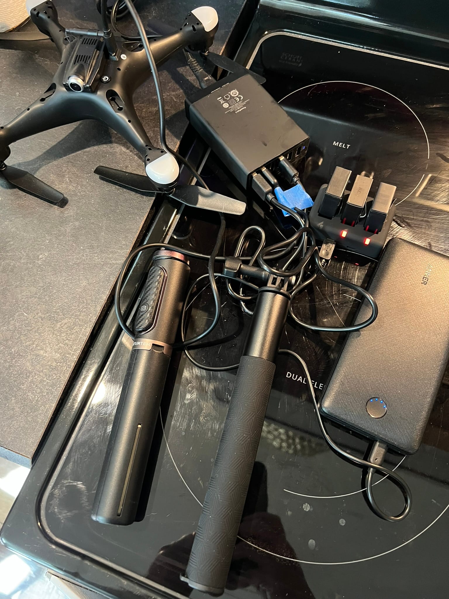 Drone, cameras, and charging equipment prepared for tiny house delivery filming