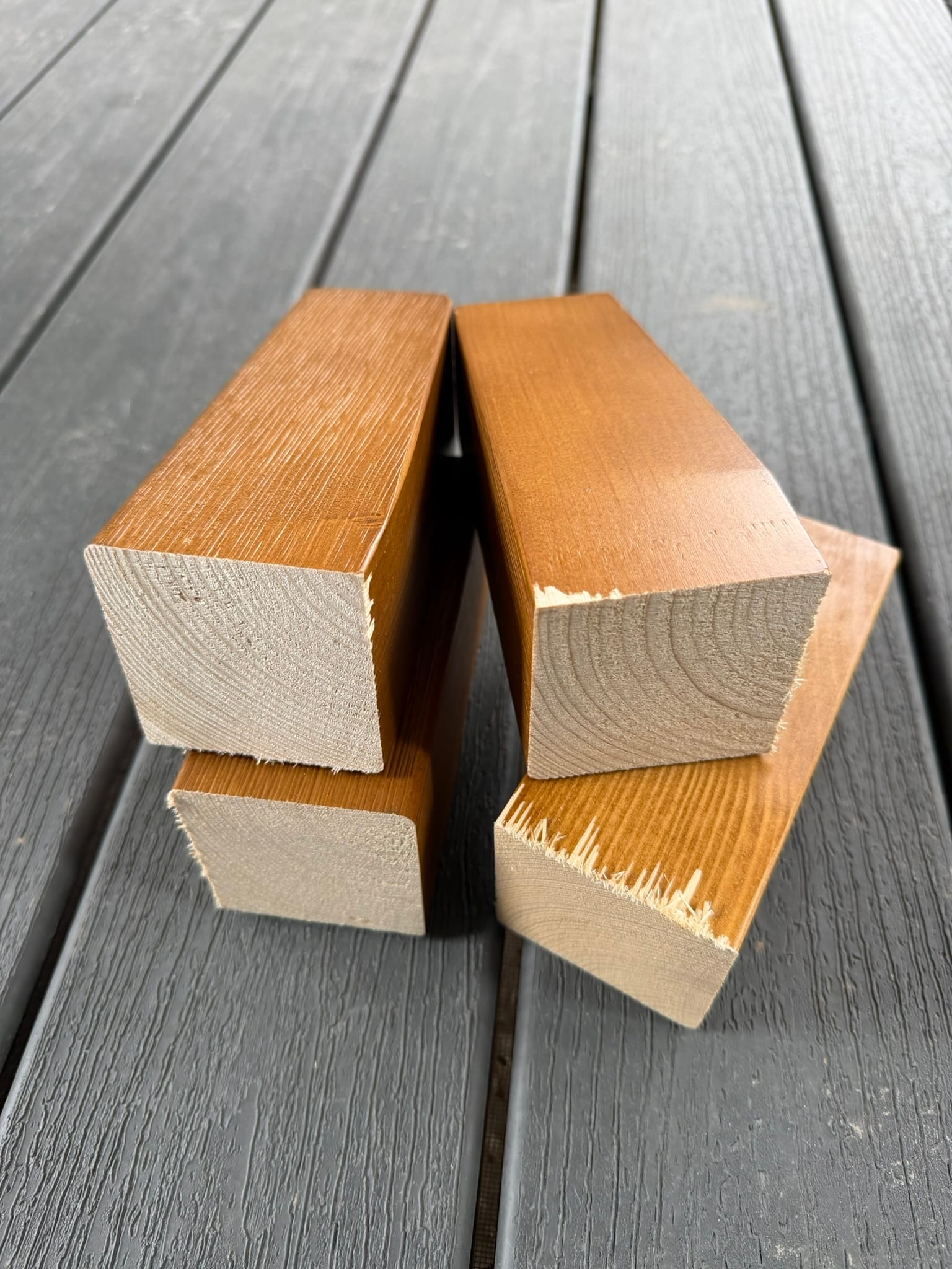 Cut wooden bed frame legs showing raw wood ends, demonstrating height modification for tiny house loft clearance