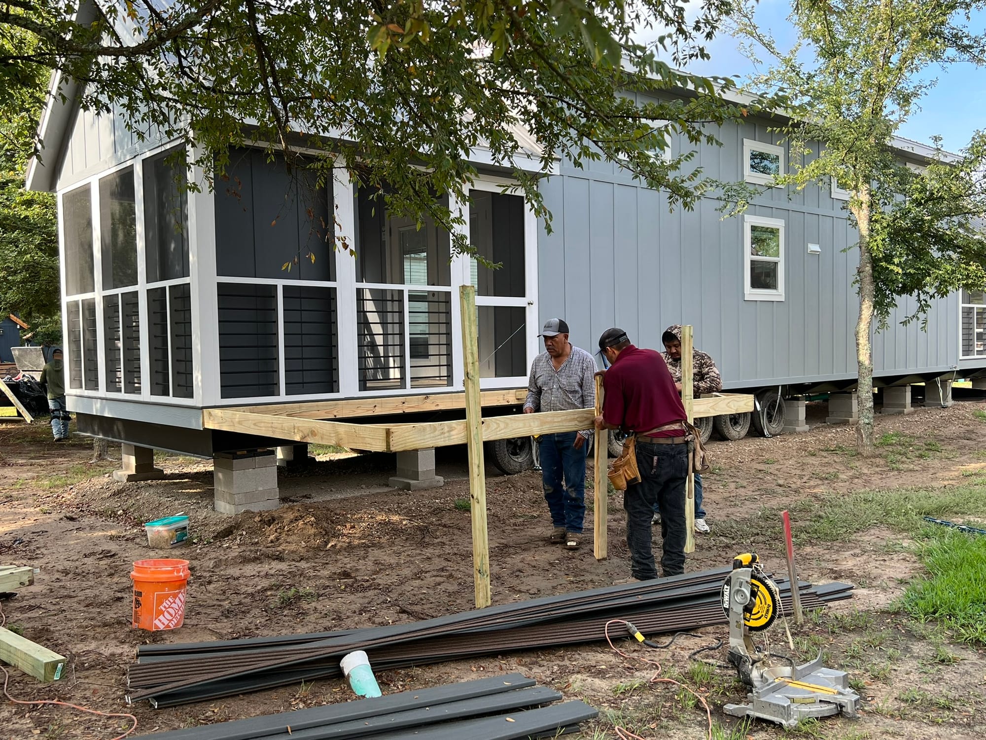 Construction crew installing metal stairs on Labor Day at tiny house community