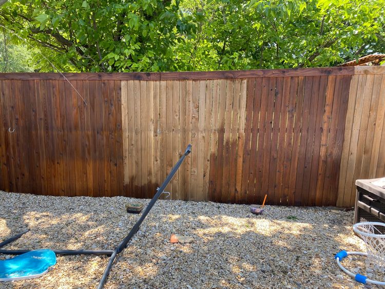 Half-stained backyard fence awaiting completion - a spring maintenance project we're ready to trade for adventures.