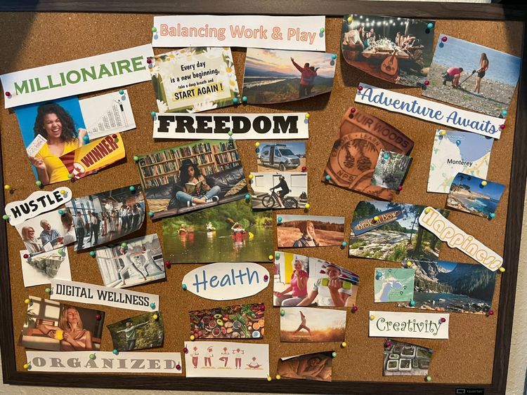 Cork board vision board with photos and words including "Freedom," "Millionaire," "Adventure Awaits," "Health," "Happiness," and "Balancing Work & Play" representing life aspirations.