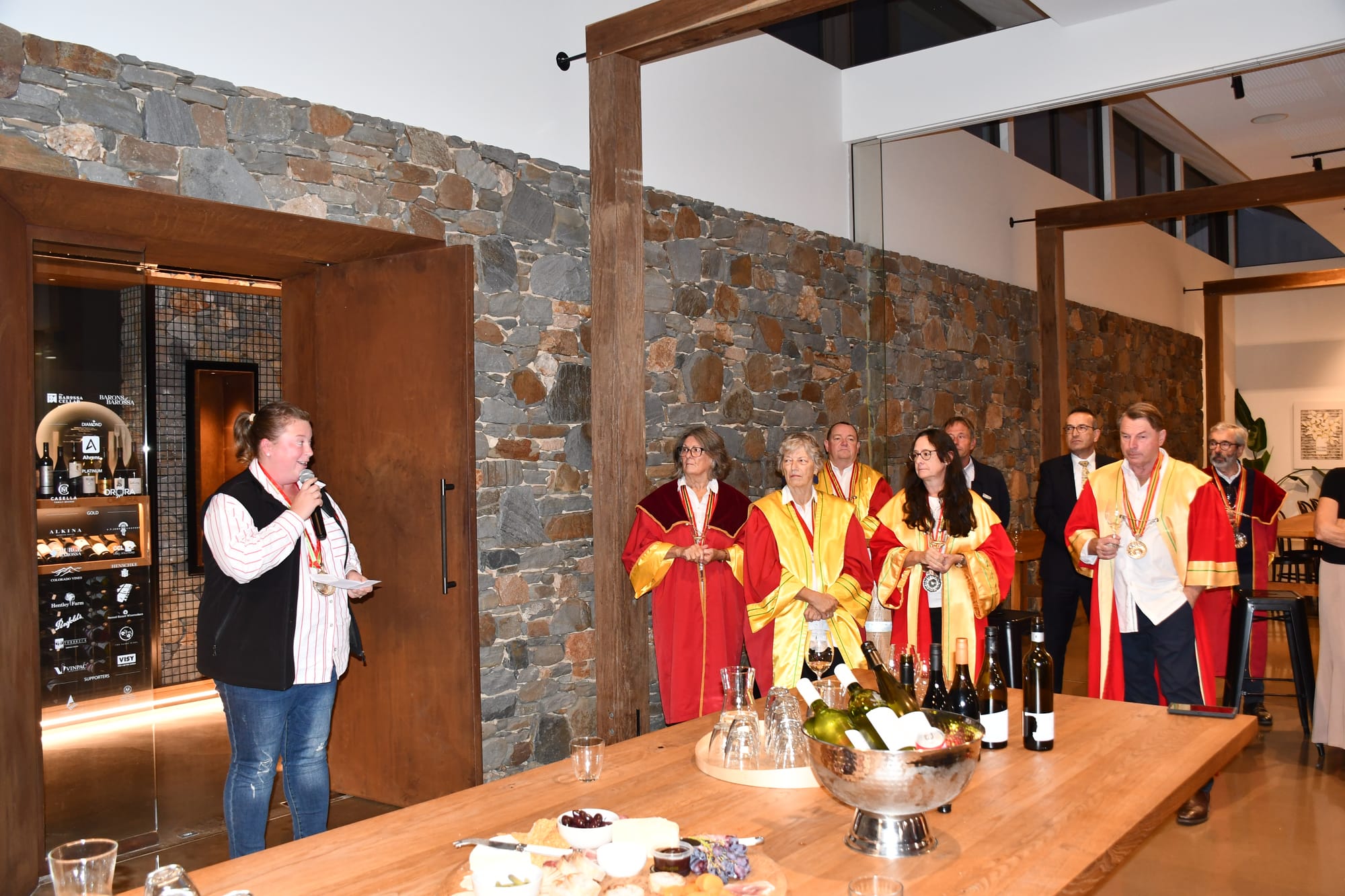 Chair of the 2025 Barossa Vintage Festival, Carla Wiese-Smith, with Barons of the Barossa and other guests watching on.