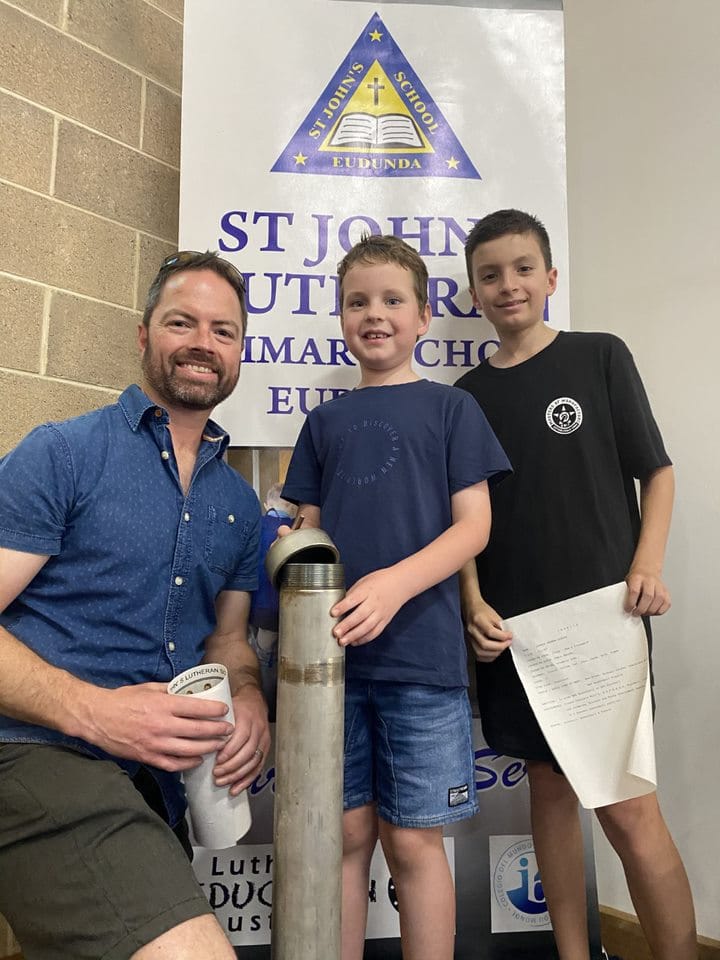 Joshua Schutz, Mason Schutz and Kody Schutz uncovered items from the time capsule.